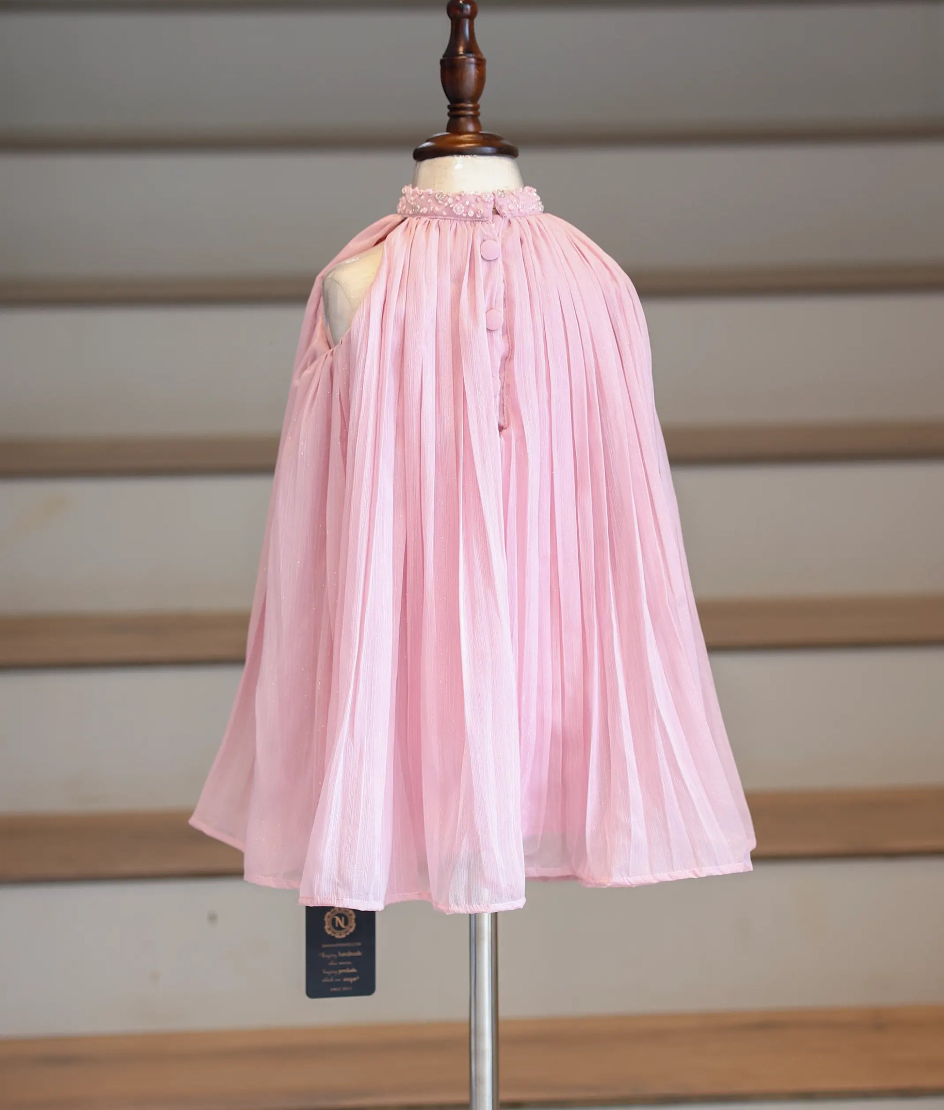Back view of the pink shimmer georgette frock showing the high-neck finish.