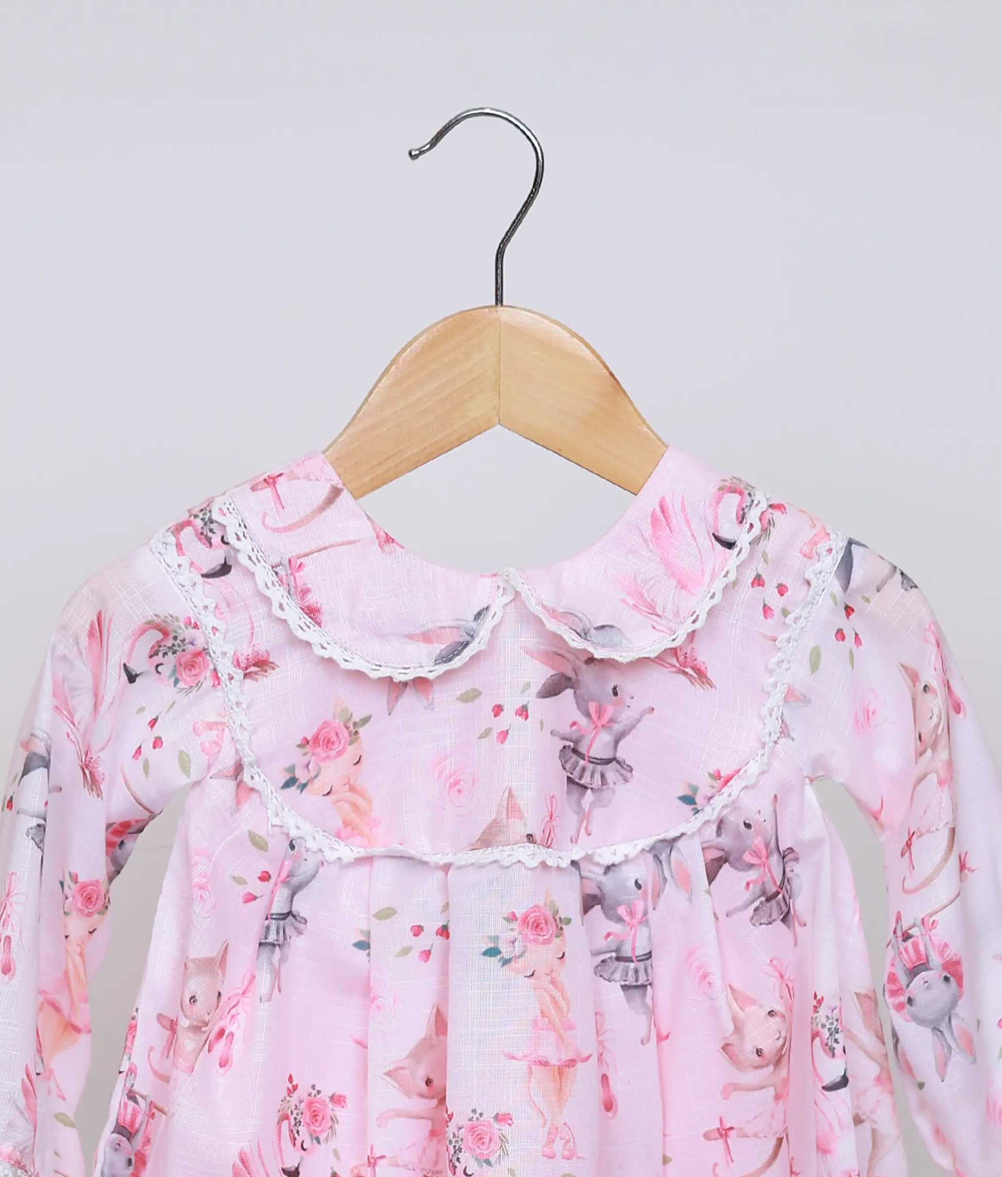 Close view of the peter pan collar on the pink animal print dress, highlighting the delicate lace trim detail.