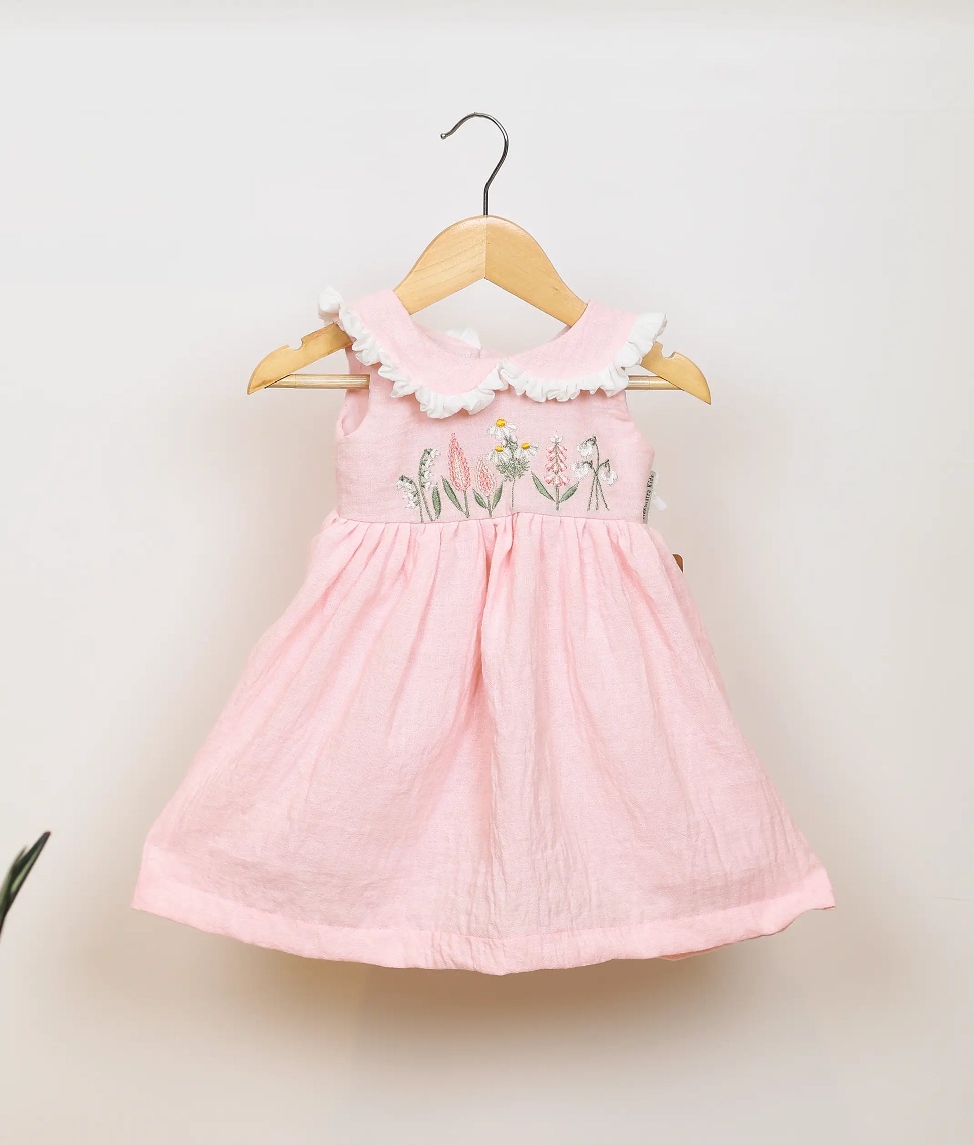 Pink linen sleeveless frock with a Peter Pan collar and delicate floral embroidery yoke for baby girls.