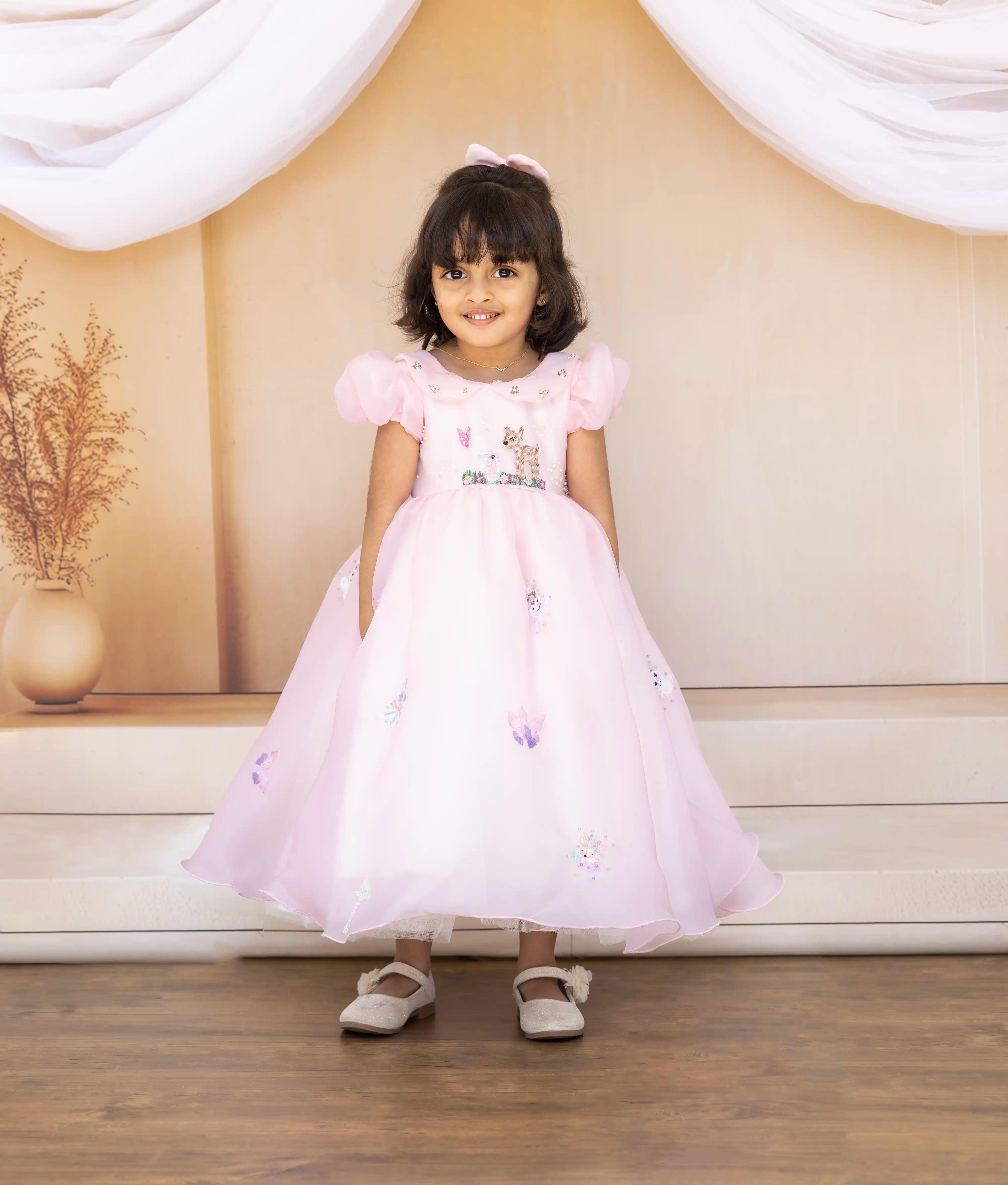 Front view of a pink plain organza theme birthday frock for girls with 3D butterfly and animal embroidery
