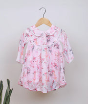 Pink baby girl frock with dancing animal print, peter pan collar, and full sleeves.