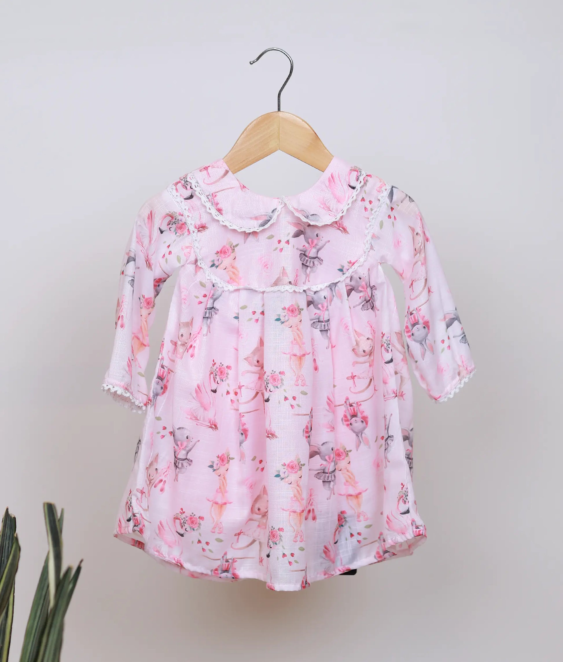 Pink baby girl frock with dancing animal print, peter pan collar, and full sleeves.