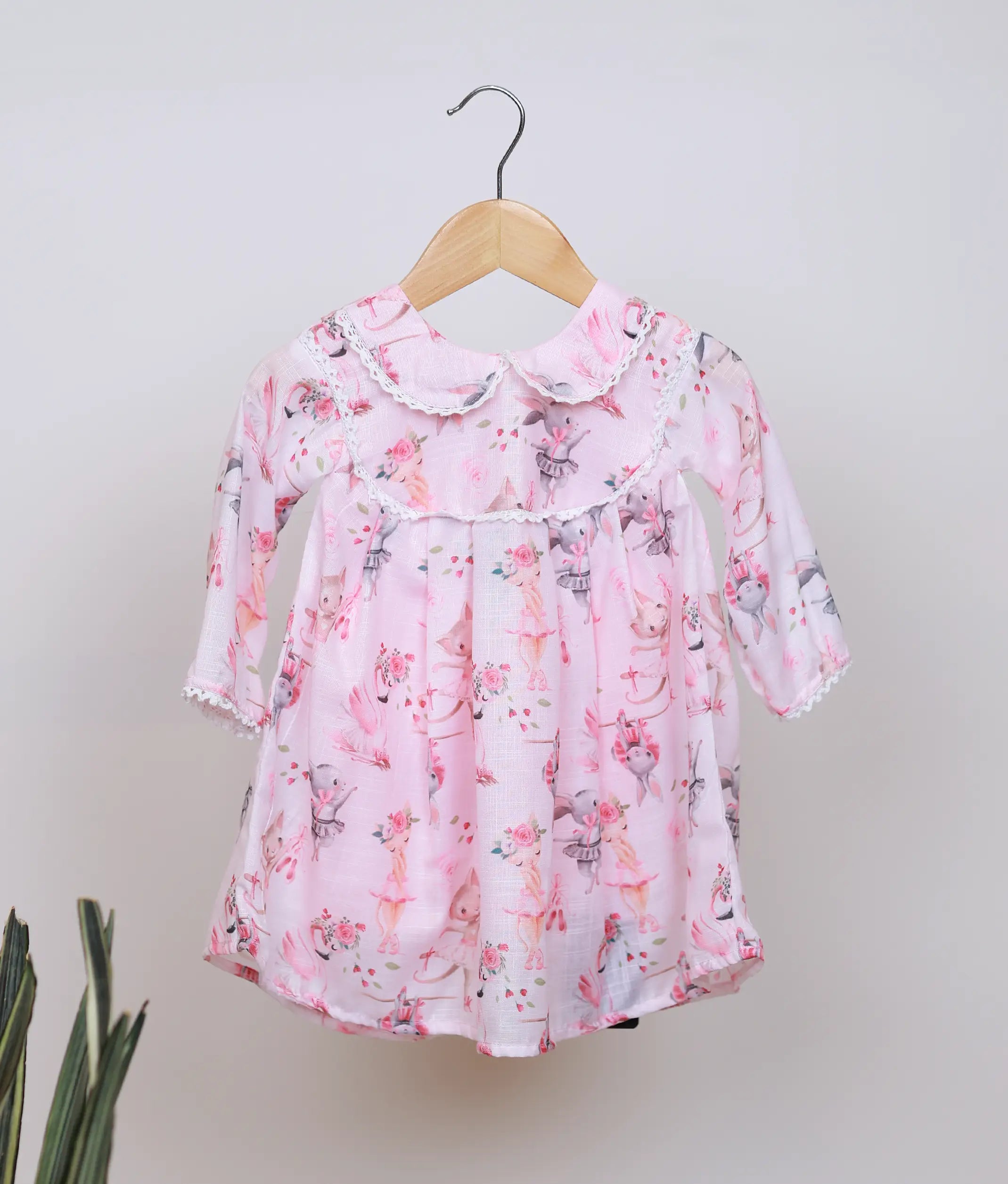 Pink baby girl frock with dancing animal print, peter pan collar, and full sleeves.