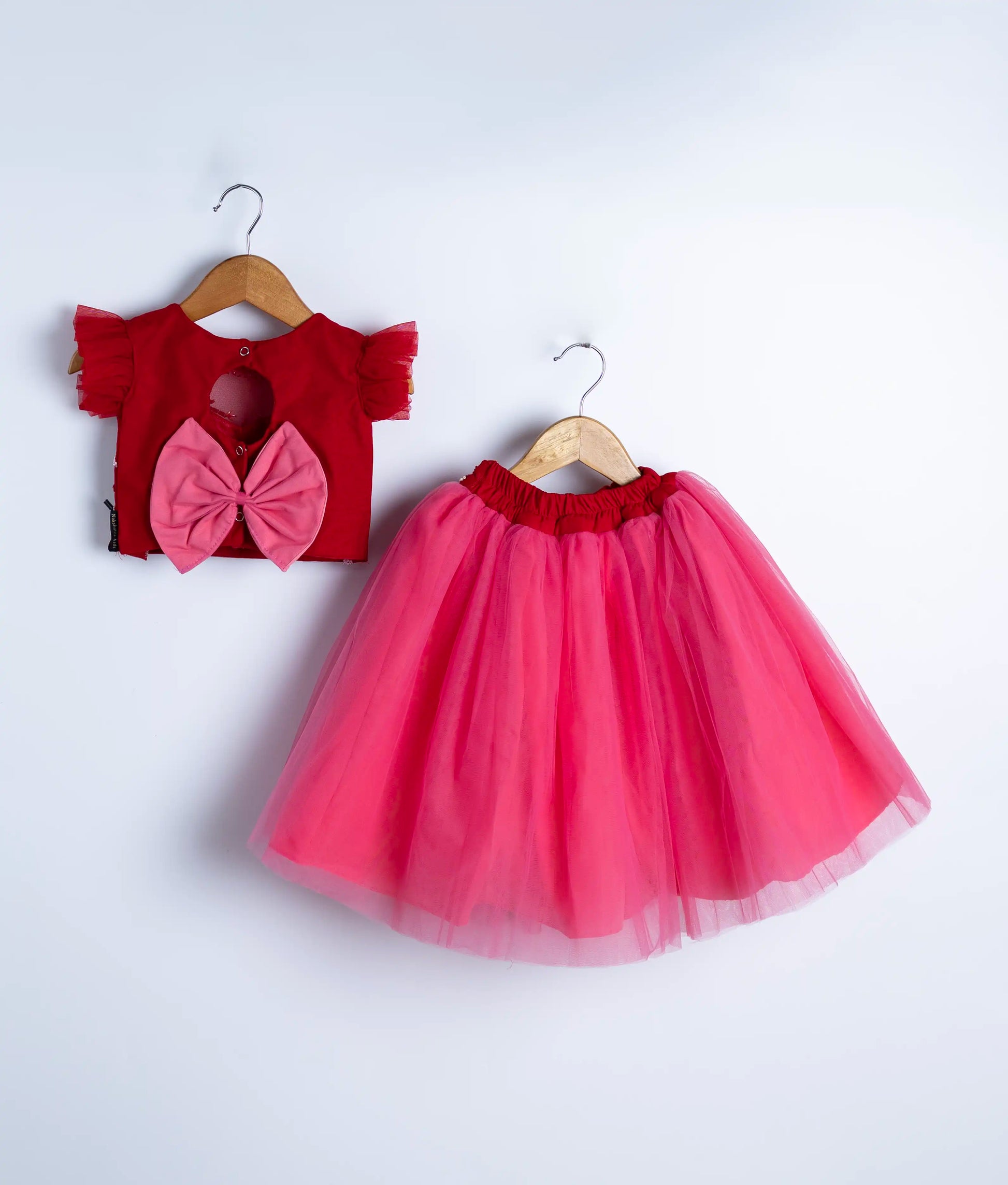 Full display of pink and red swan theme party dress with flowing tulle net skirt for baby girls