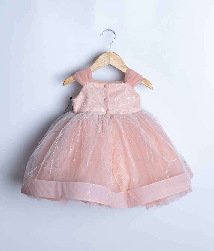 Back view of pink baby girl birthday dress showing square neck and layered tulle bottom.