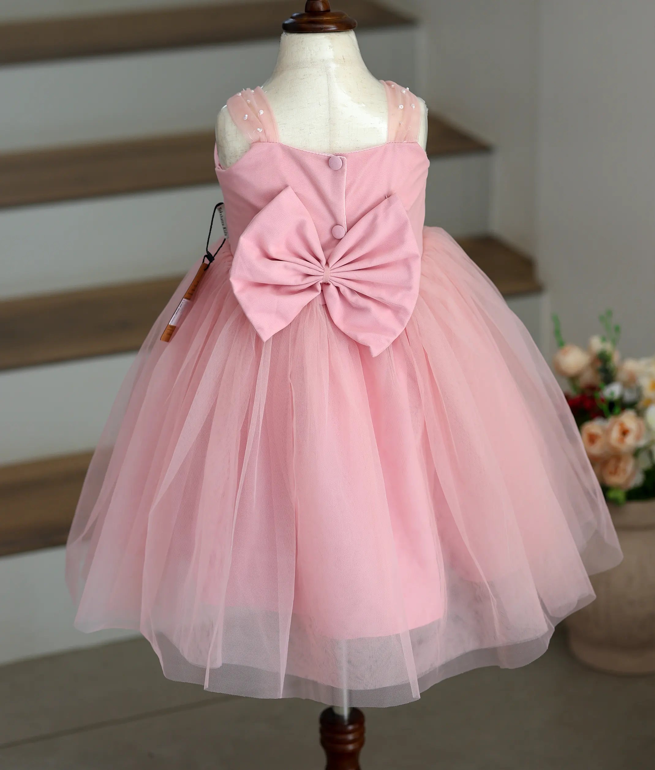 Back view of the pink tulle net frock showing the neat closure and fluffy layers.