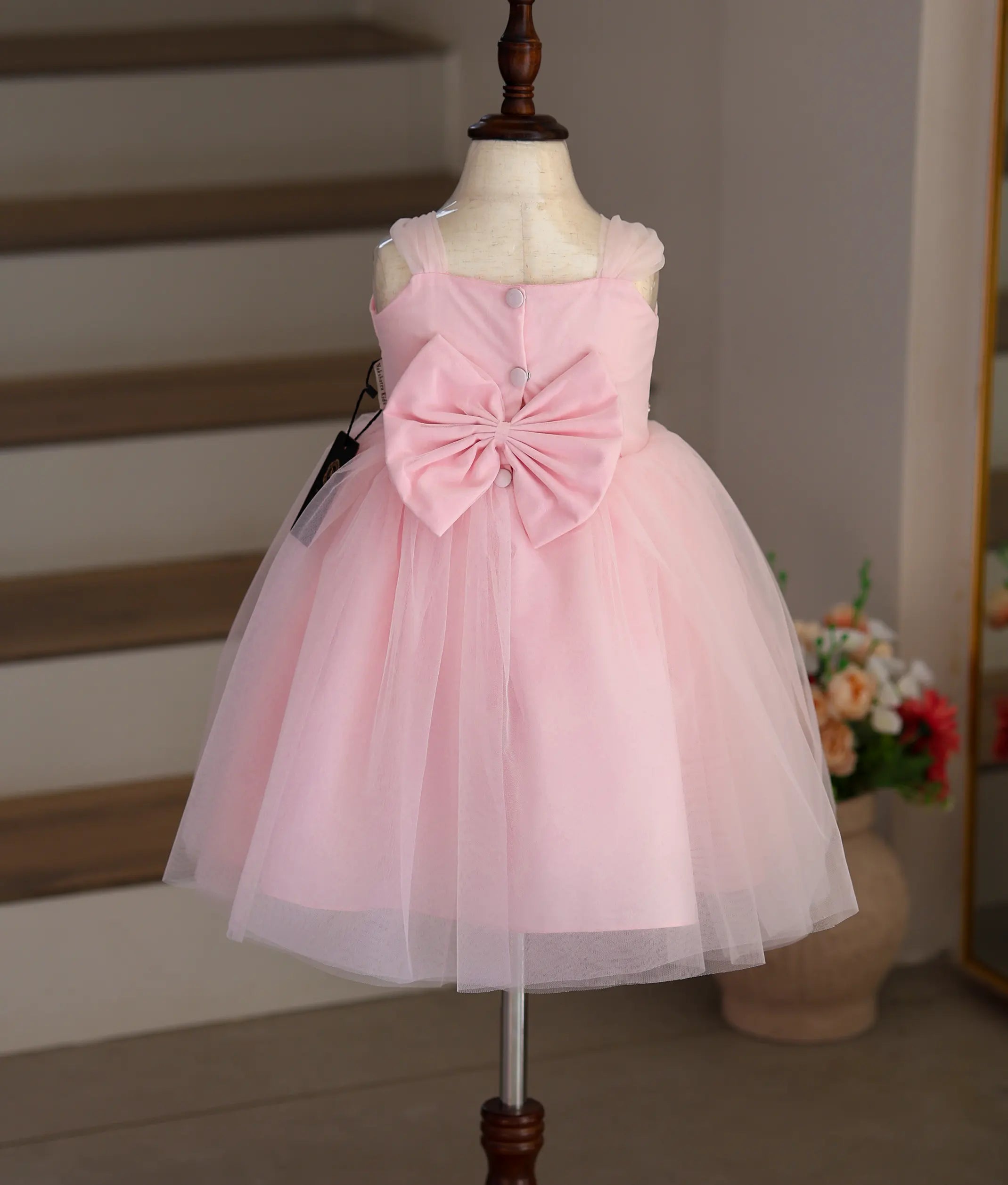 Back view of the pink tulle net frock showing the neat closure and fluffy layers.