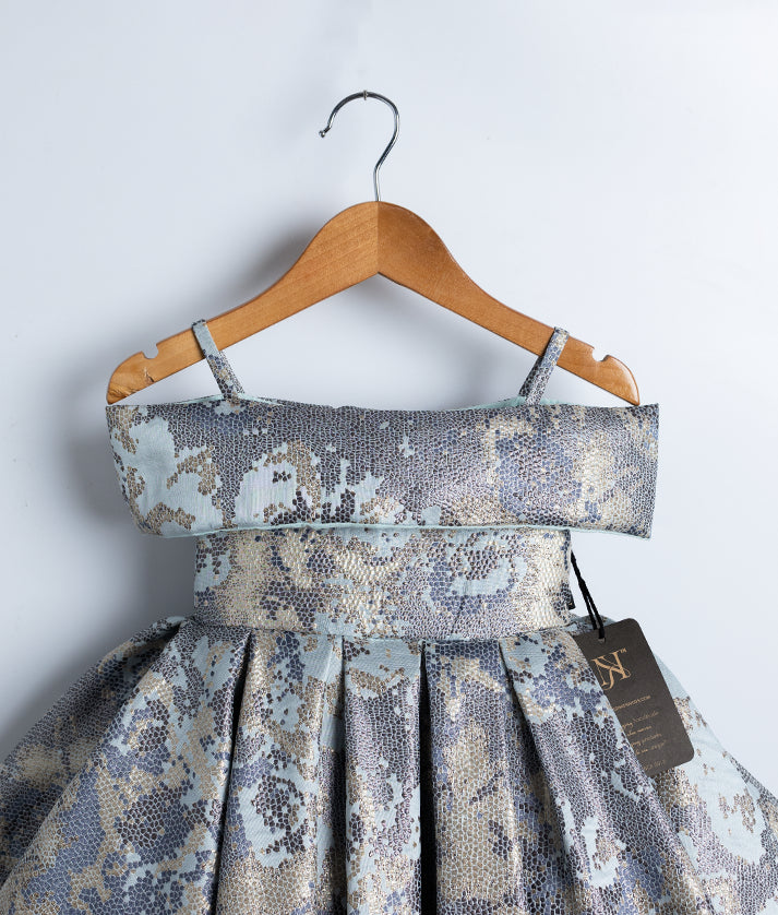 Detail view of the pleated, flowing Jacquard skirt giving a rich royal look