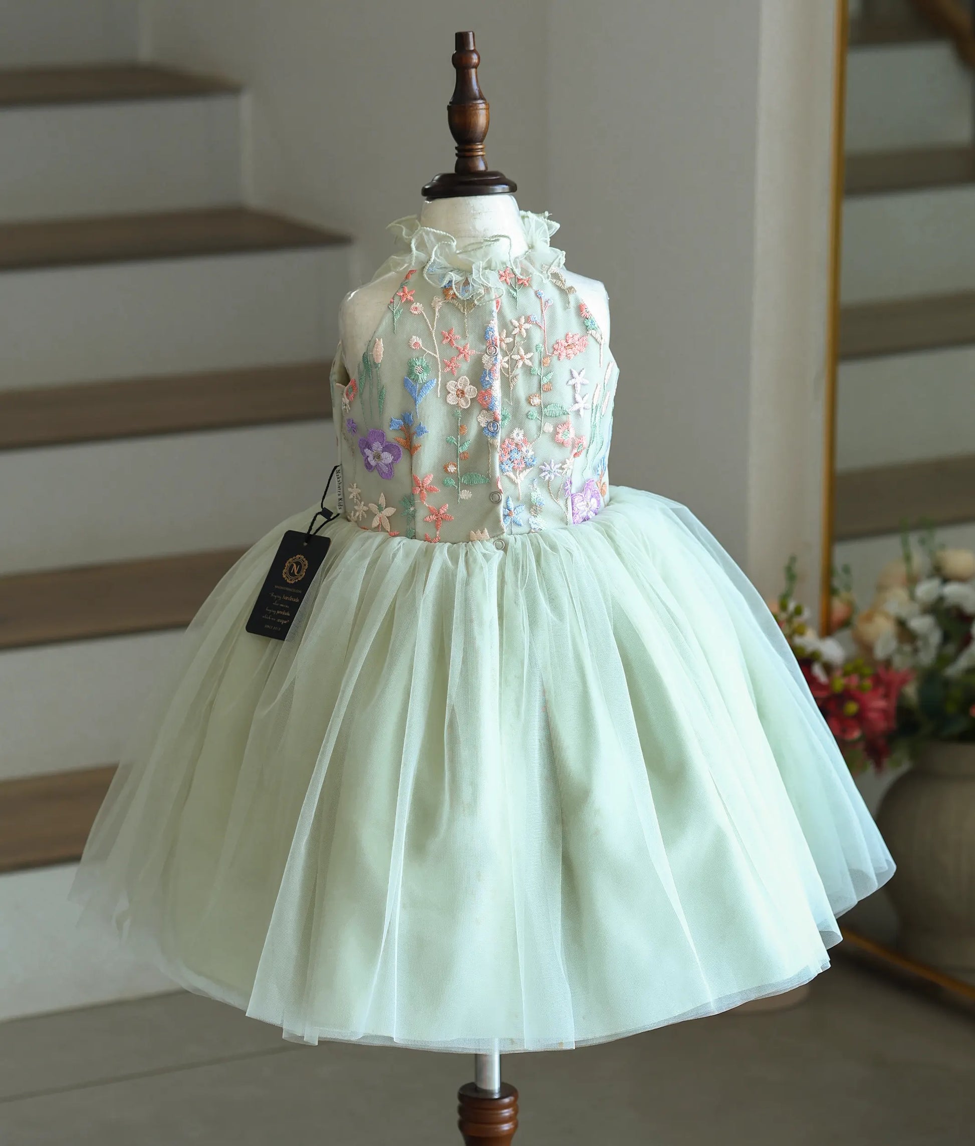 Back view of the powder green frock showing the button closure.