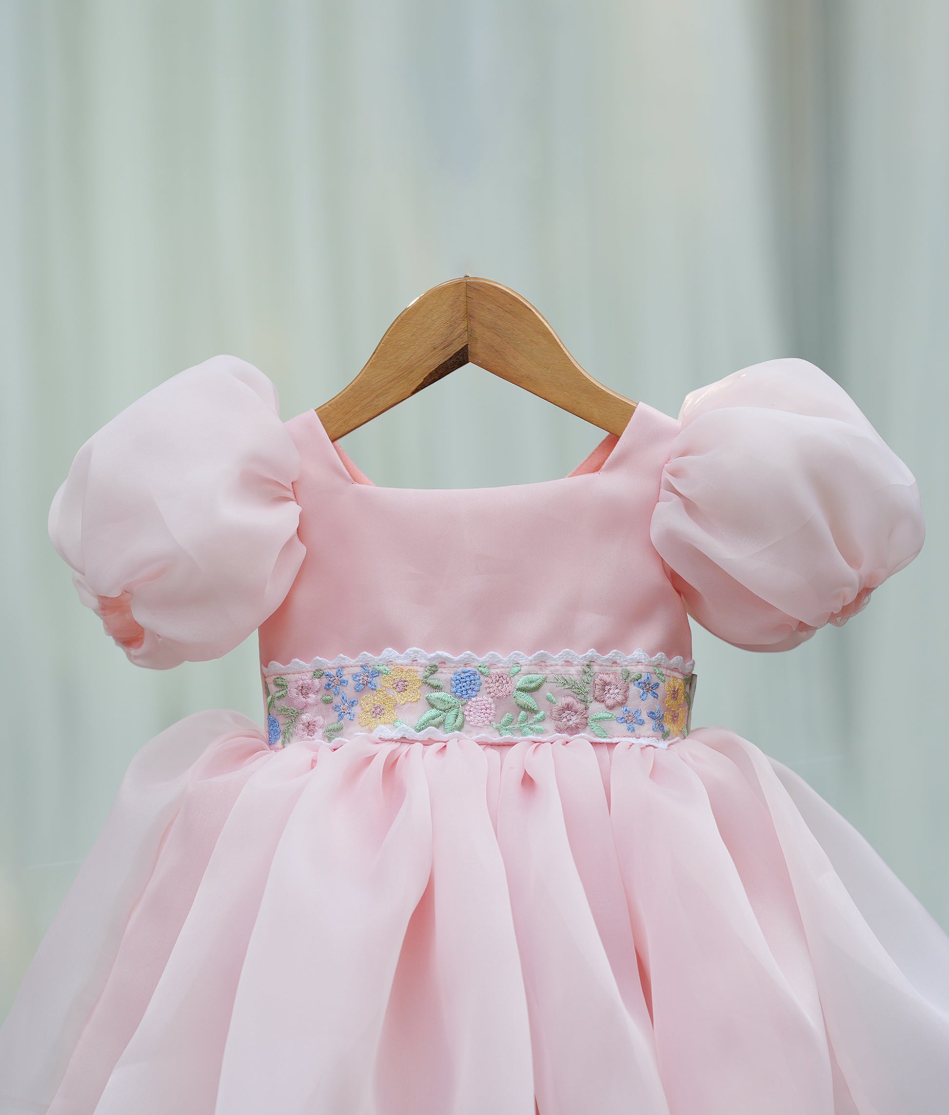 Close-up of the peach bodice showing the square neckline and the shimmering belt with detailed embroidery