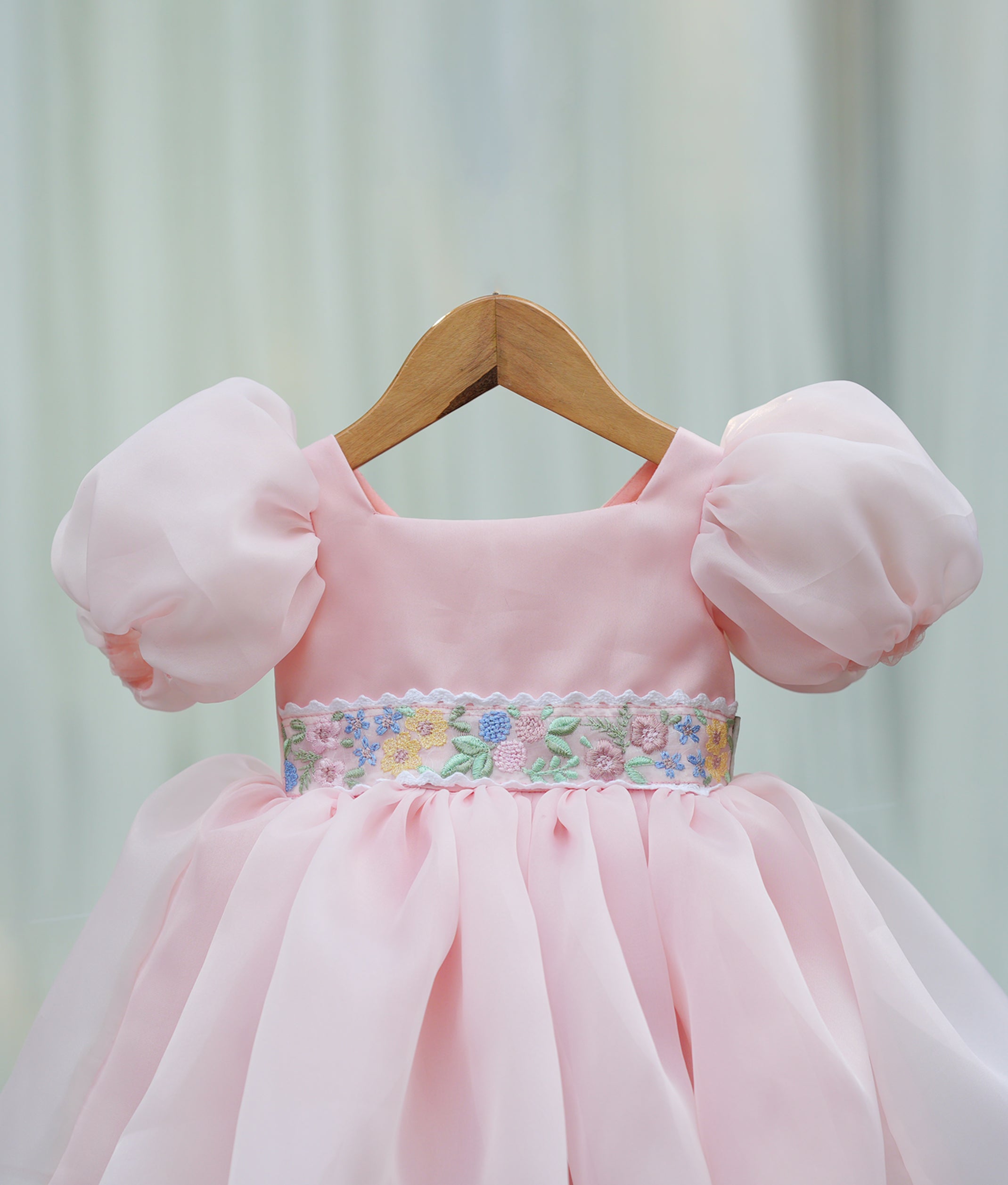 Close-up of the peach bodice showing the square neckline and the shimmering belt with detailed embroidery