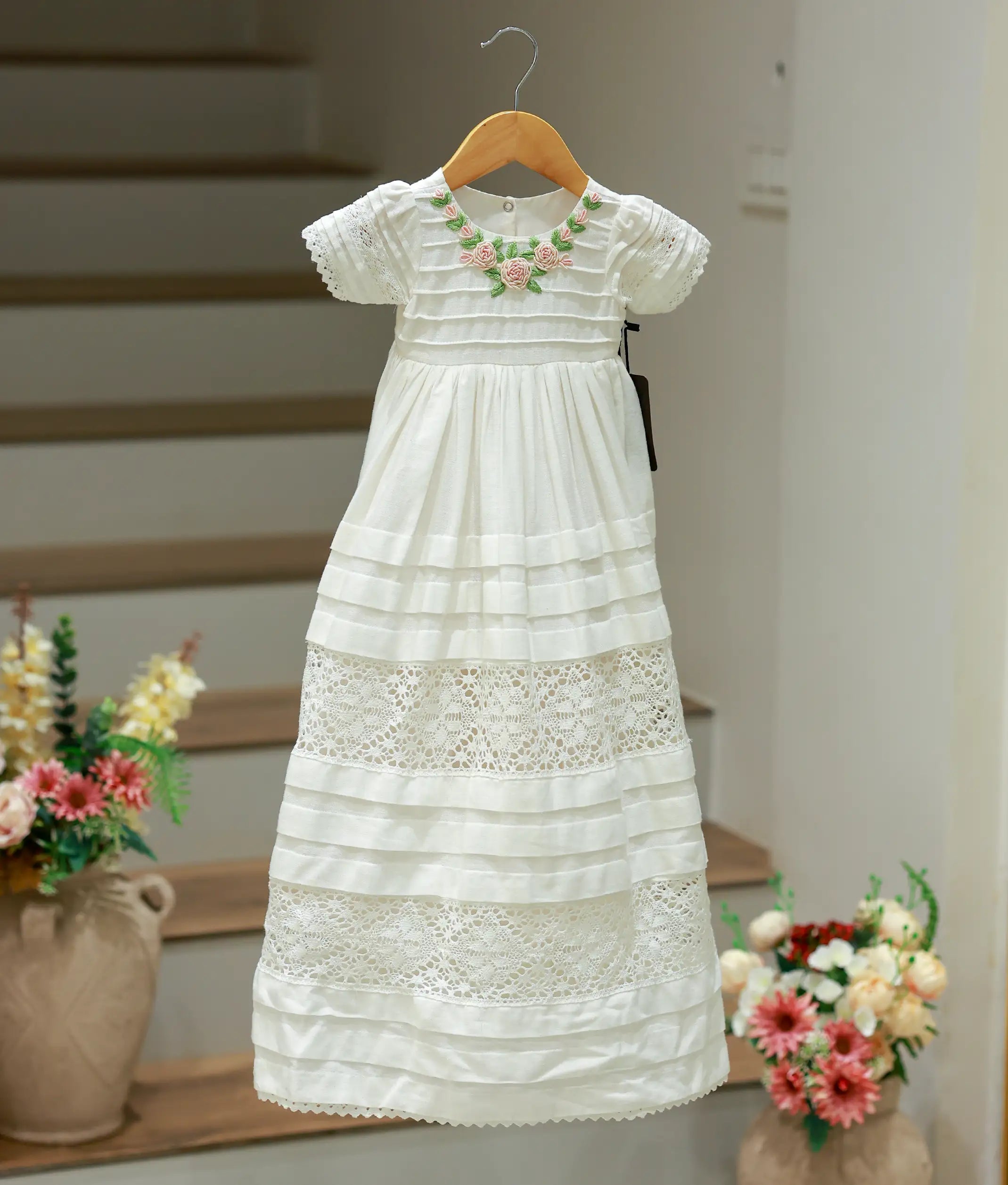 Front view of a pure white baptism lace frock for baby girls with a layered tulle skirt