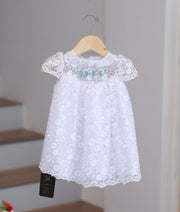 Pure white baby girl baptism frock featuring handcrafted pearl embroidery and delicate lace detailing