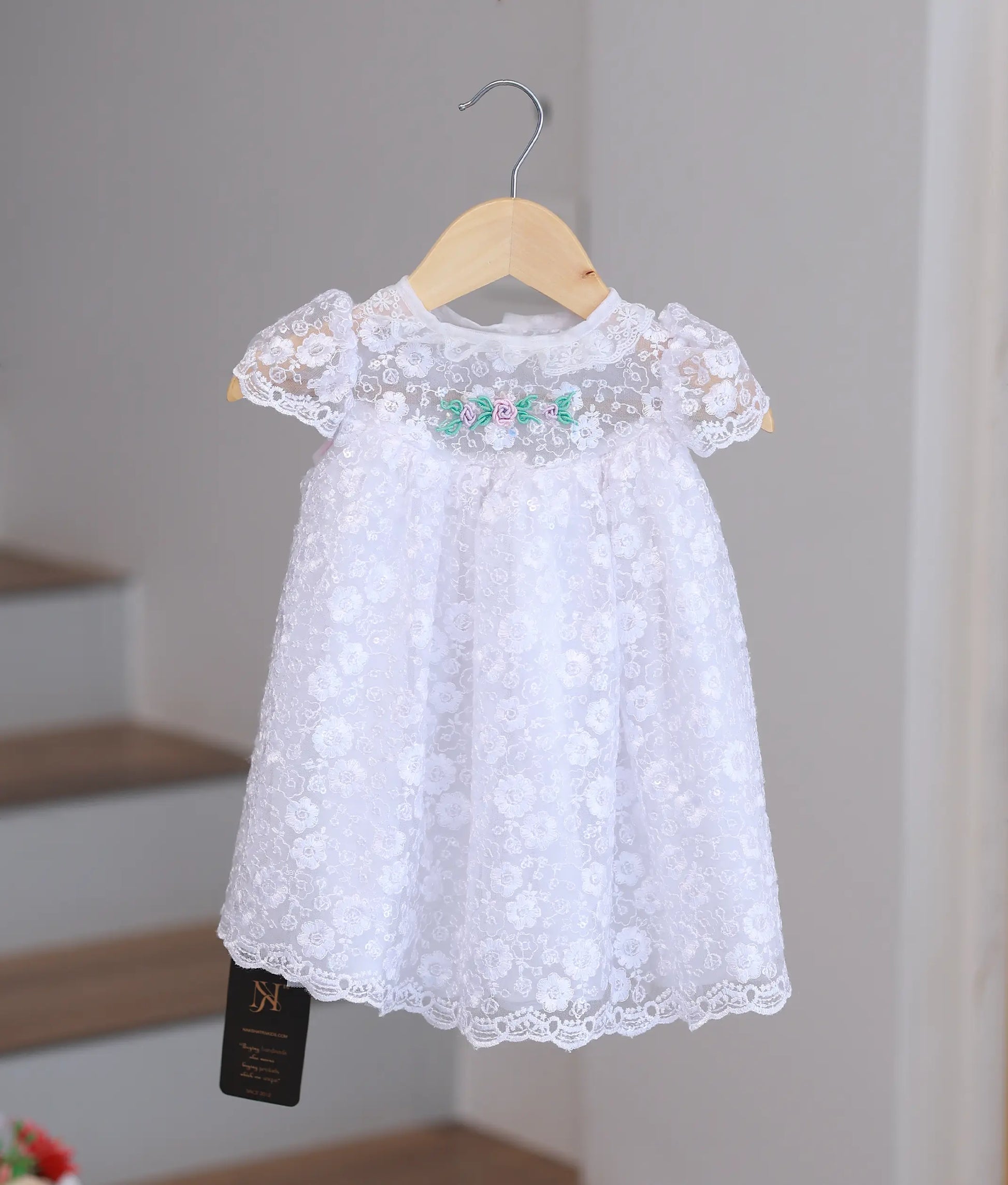 Pure white baby girl baptism frock featuring handcrafted pearl embroidery and delicate lace detailing