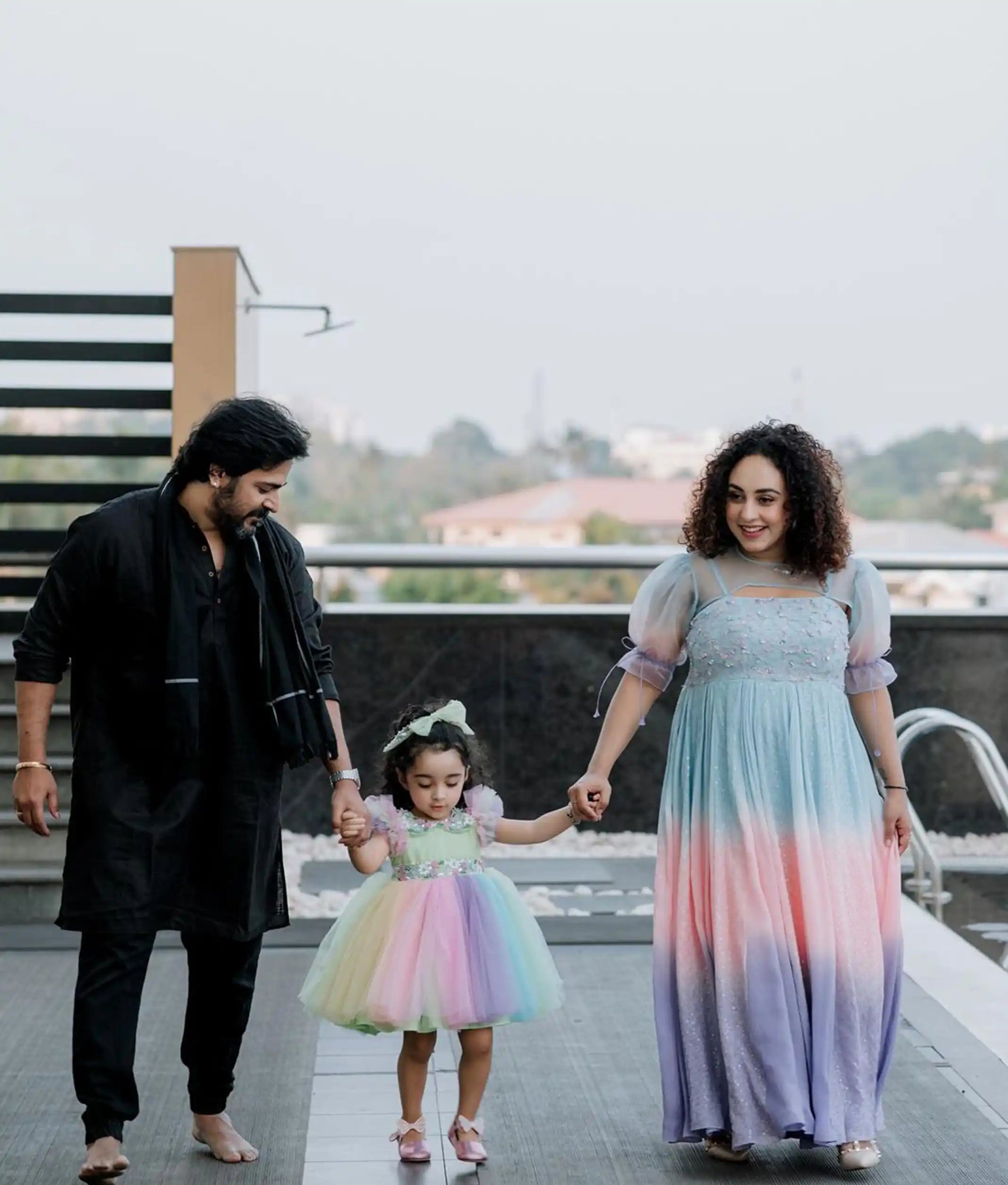Baby girl wearing a multicolored tulle net birthday frock with a Peter Pan collar and butterfly sleeves