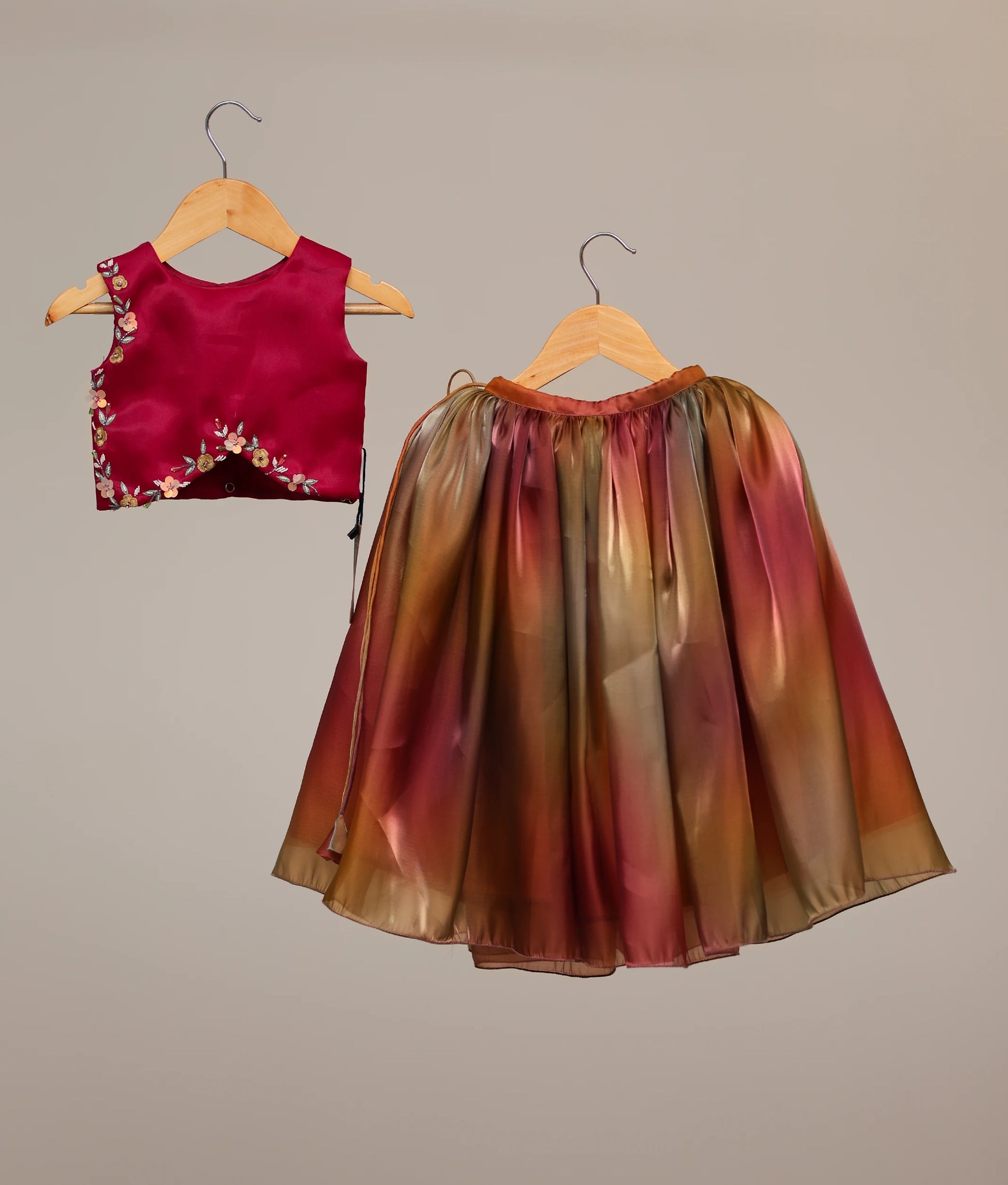 Front view of the rani pink organza handworked top and multi-shade gradient skirt lehenga set for girls showing the floral detailing