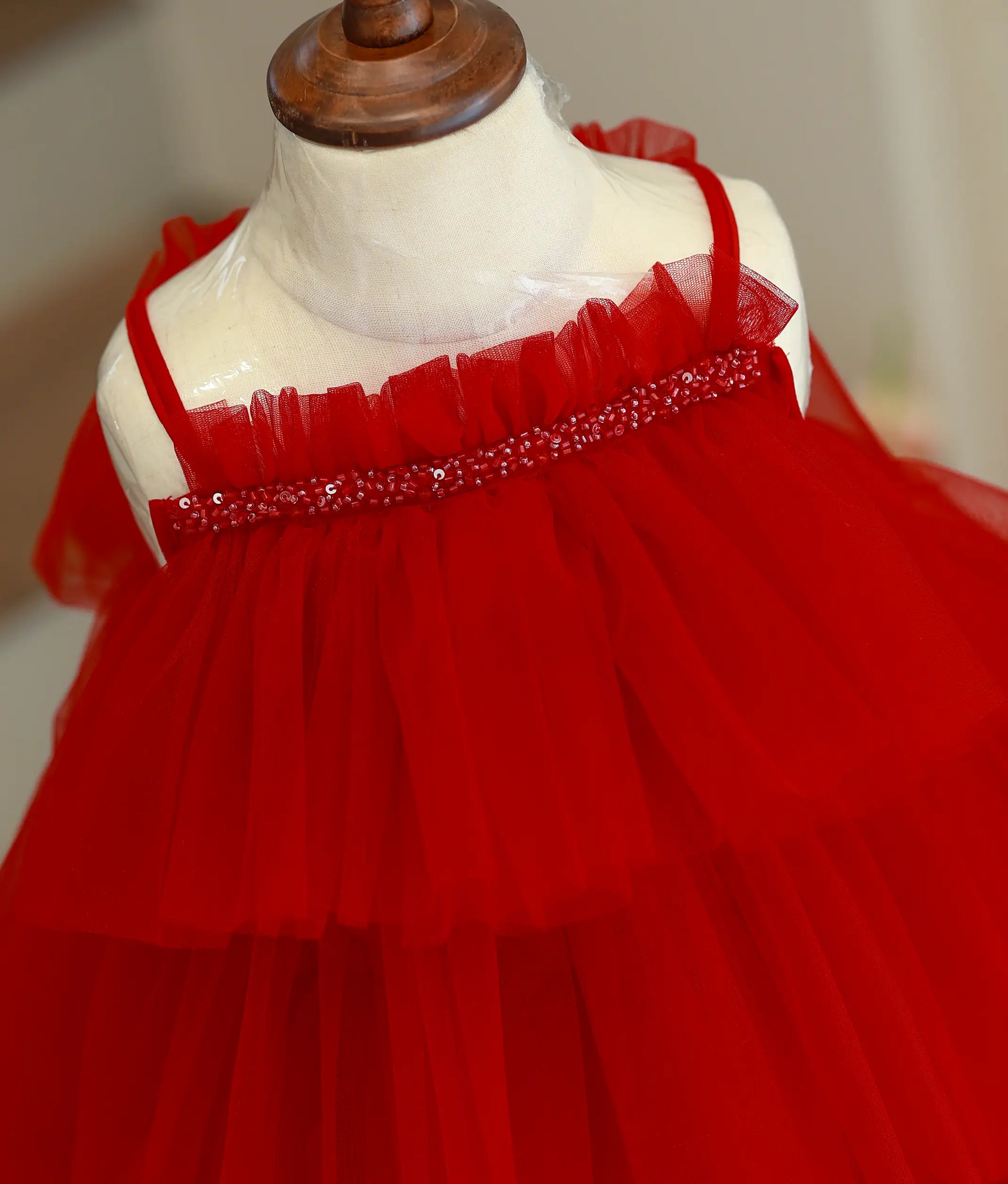 Close-up of the sequins, beads, and step-pattern tulle layers on the top of the red birthday frock.