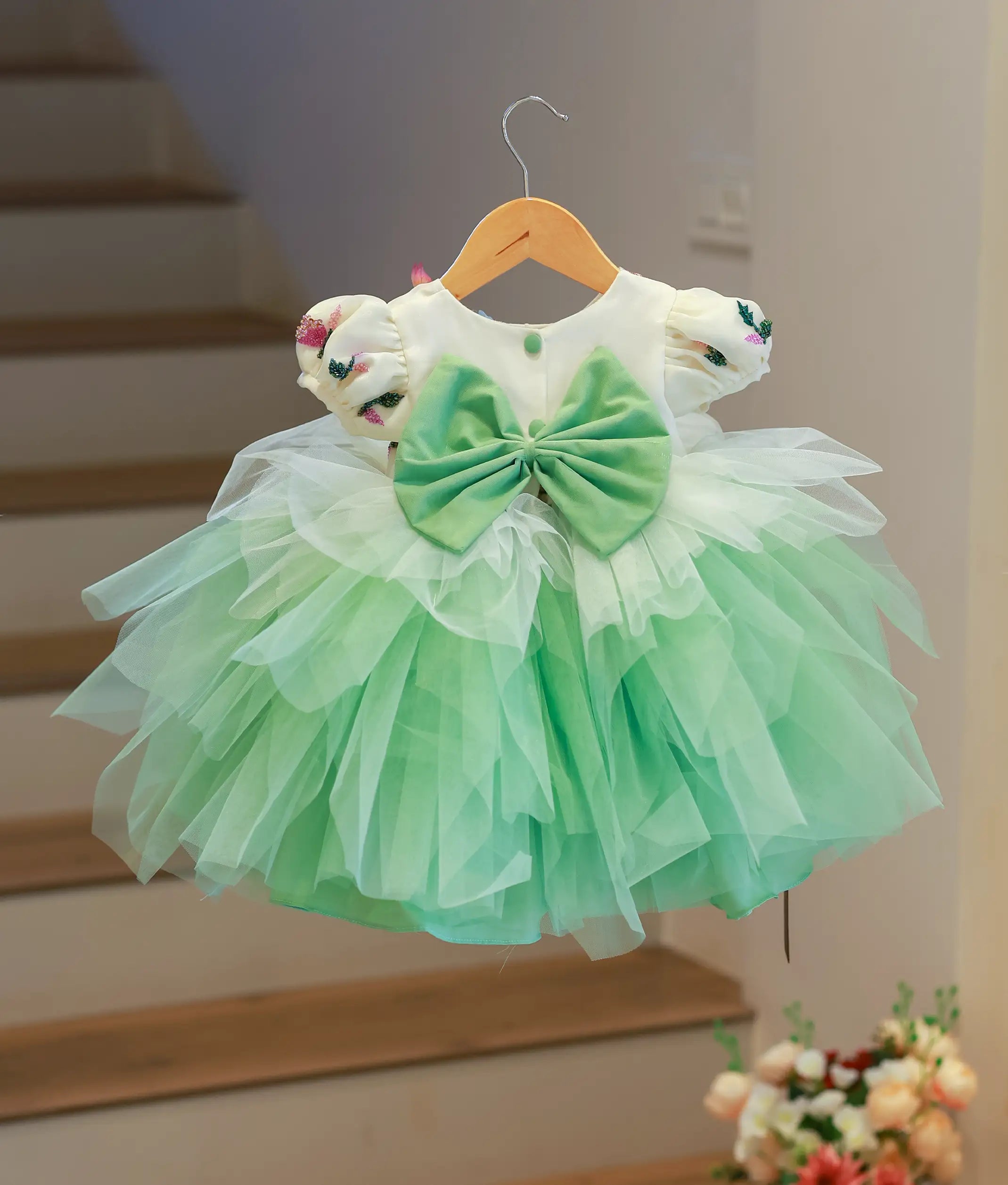 Back view of the princess theme dress highlighting the round neckline, show button, and decorative bow