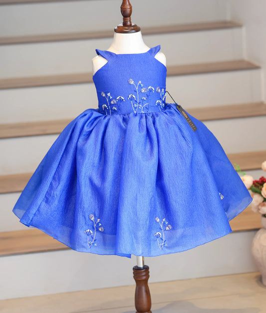Front view of a royal blue halter neck frock in crush organza with floral handwork.