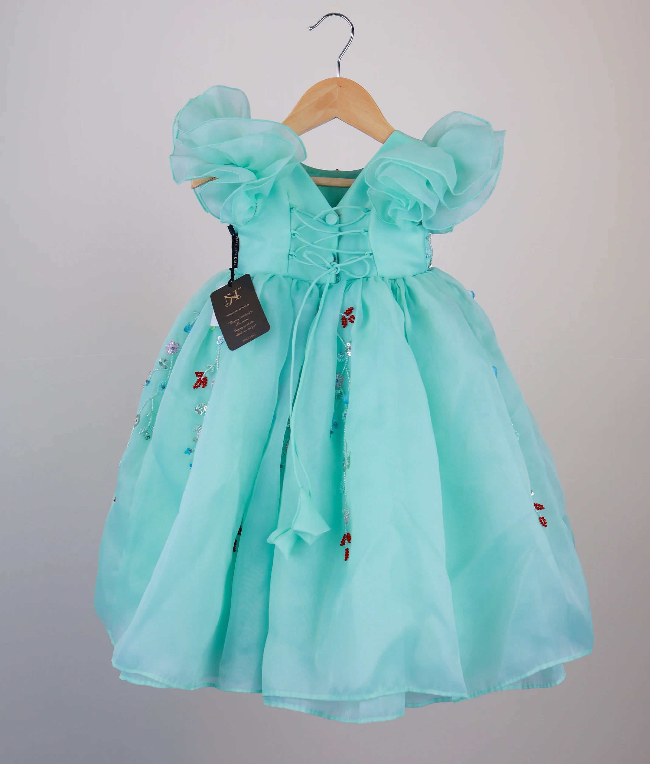 Back view of sea green gown showing the V-neck design and elegant tie-up back for a comfortable fit