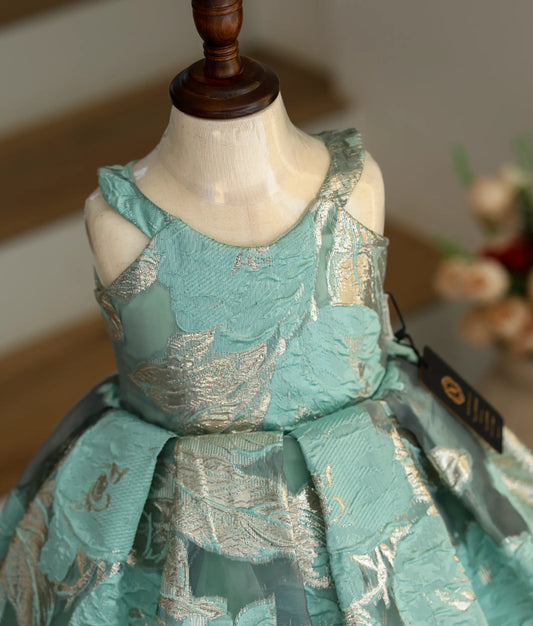 Close-up of the silver floral patterns and halter neck straps on the Turkish organza fabric.