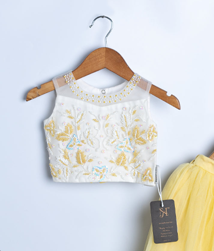 Side view of yellow baby girl dress with floral embroidered top and tulle skirt