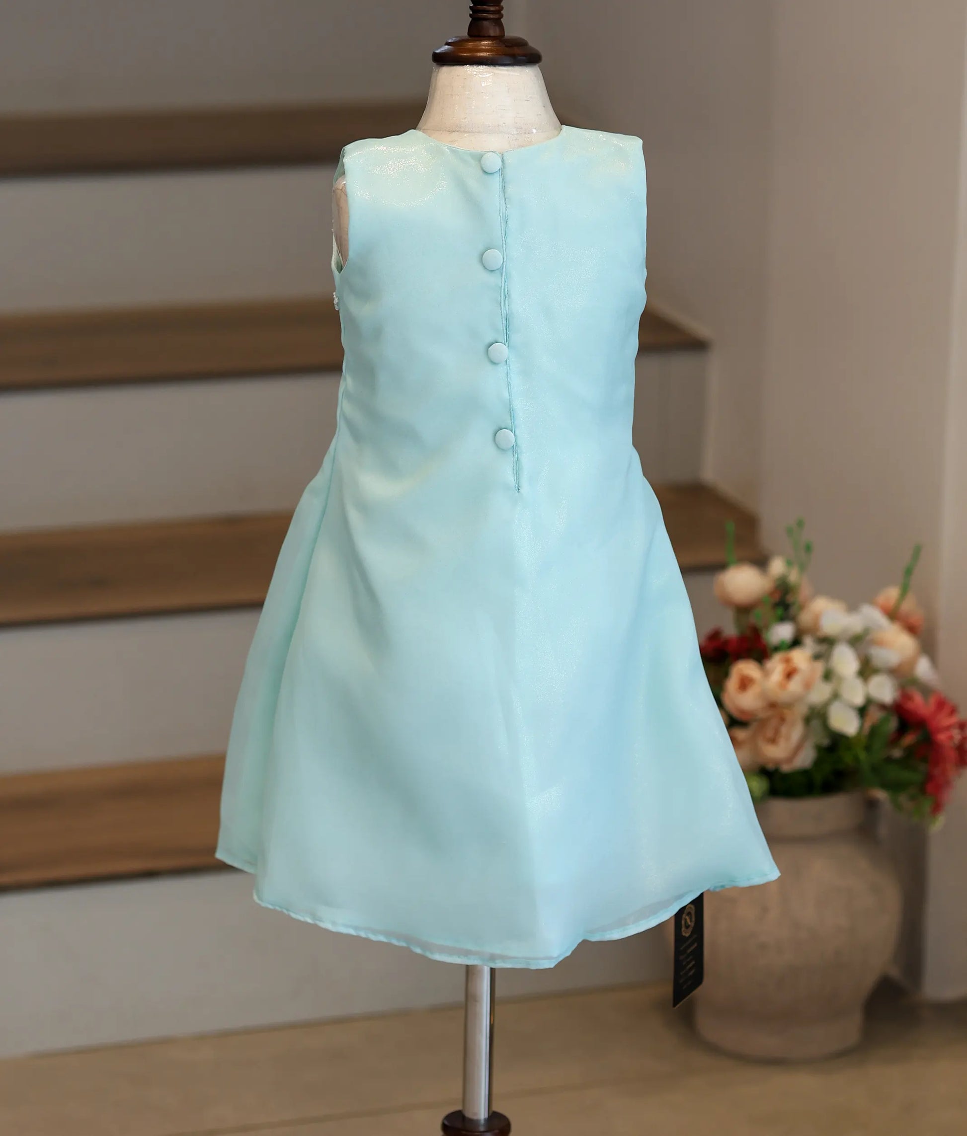 Back view of the sky blue shimmer organza frock showing the simple A-line cut.