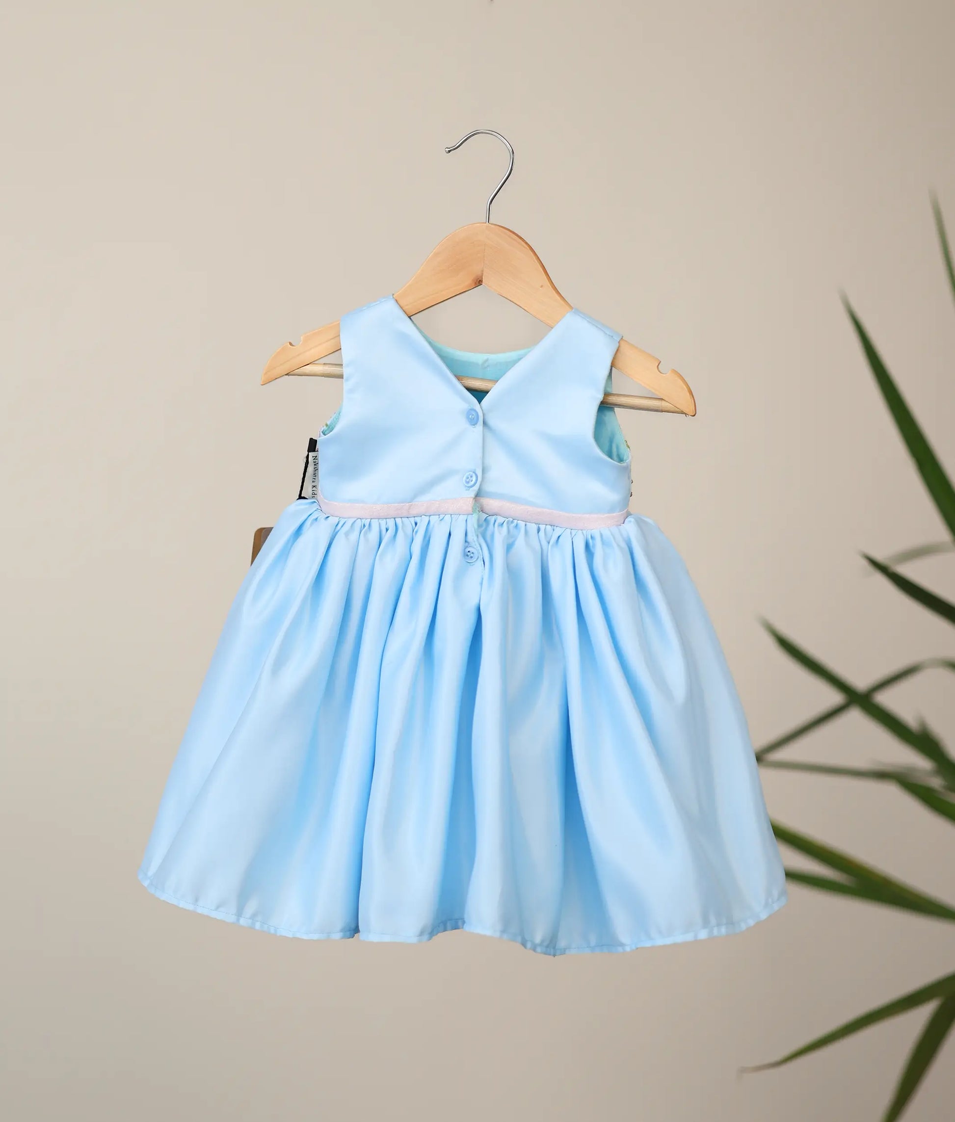 Back view of sky blue bridal satin dress showing the elegant V-neckline and the shirt button closure