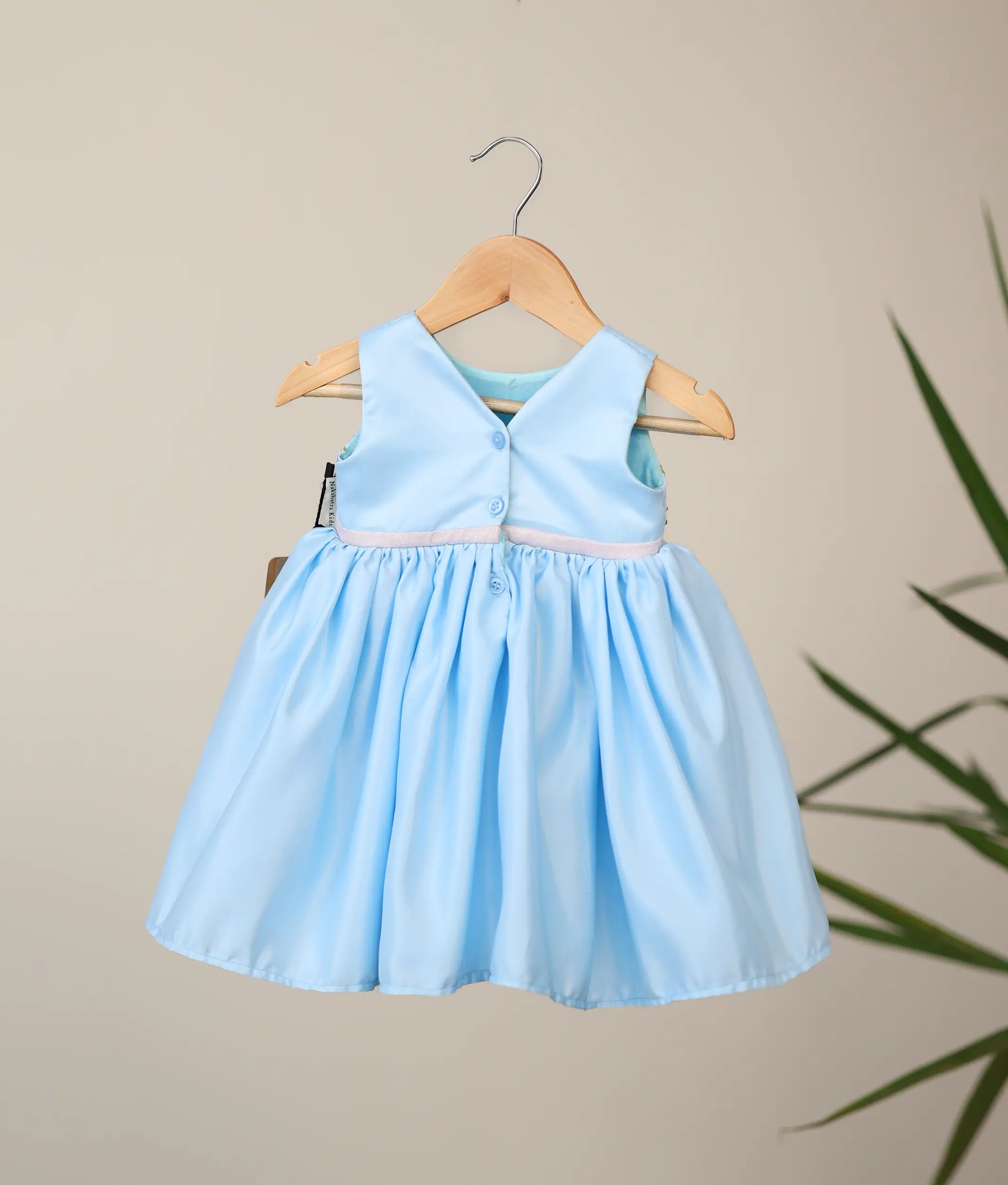 Back view of sky blue bridal satin dress showing the elegant V-neckline and the shirt button closure