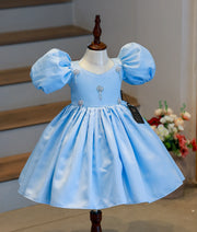 Front view of a sky blue and teal ombre Frozen theme step dress for baby girls with ruffled layers