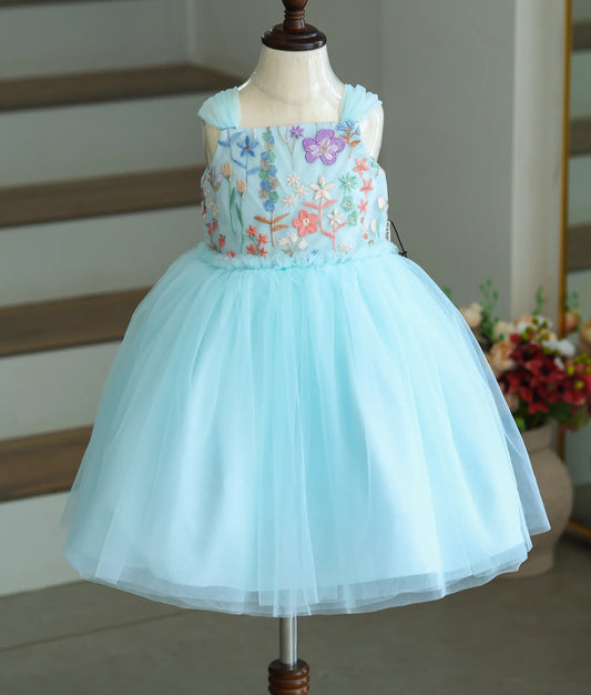 Front view of a sky blue party frock for girls with floral embroidery and a net skirt.