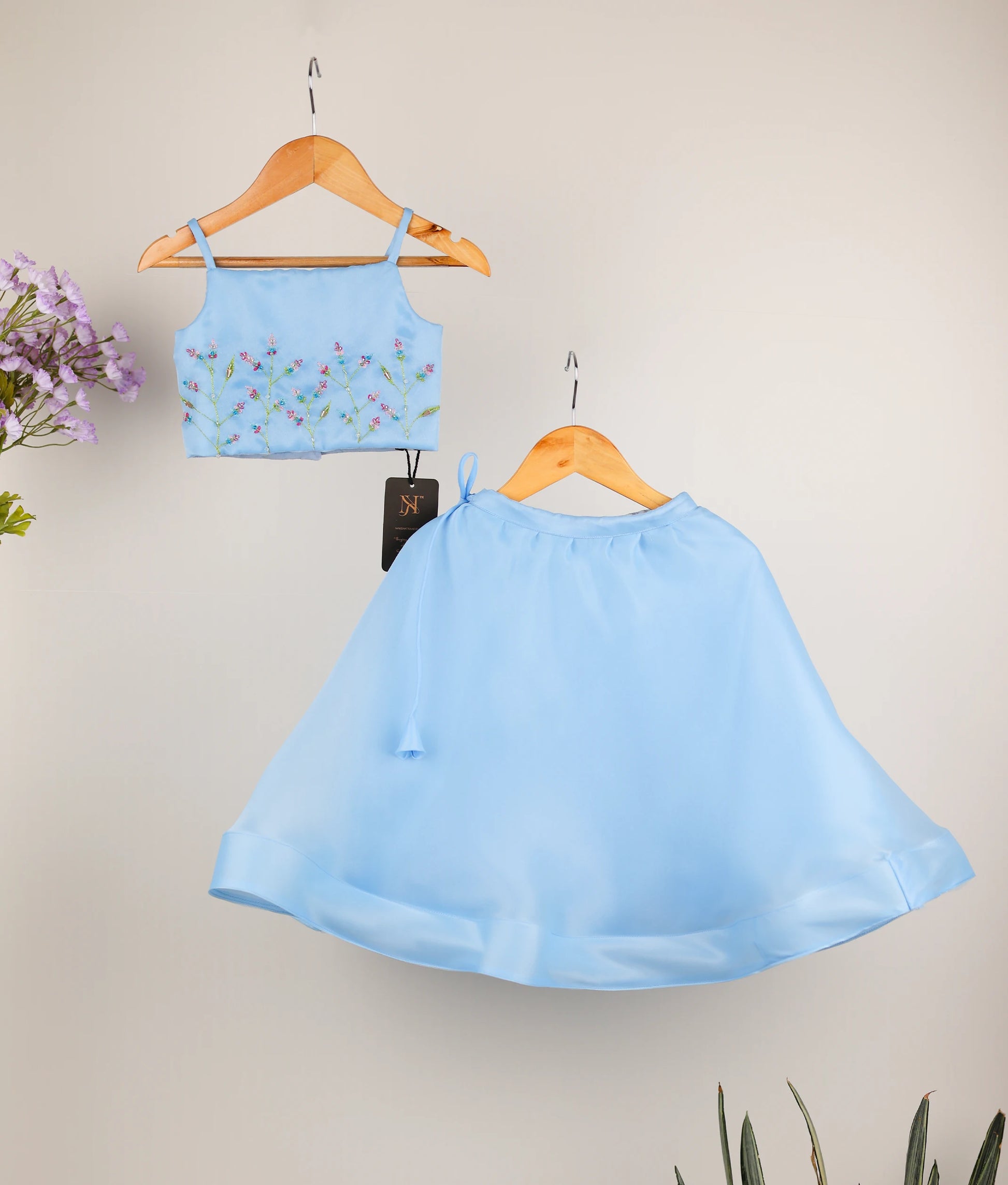 Front view of the sky blue plain organza handworked top and matching umbrella skirt set for girls showing the pastel floral embroidery