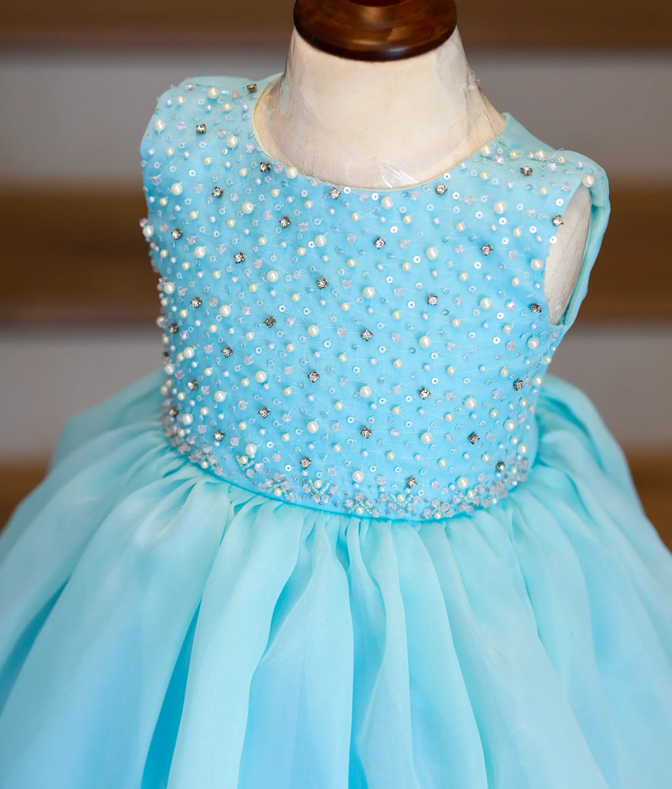 Close-up of the sky blue gown bodice showing the intricate scattered pearls, sequins, and crystal handwork