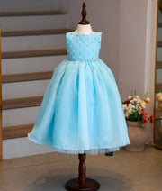 Front view of a sky blue handworked organza birthday gown for baby girls with a voluminous layered skirt
