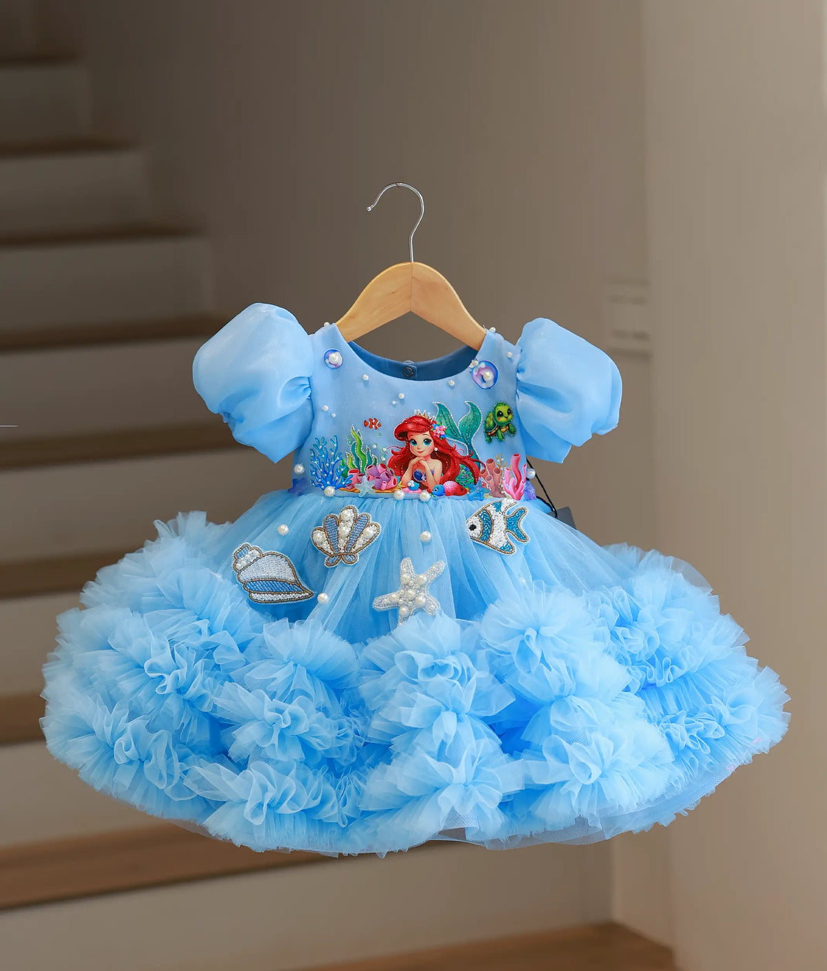 Full front view of sky blue organza and tulle net handworked mermaid-themed frock with ruffled skirt