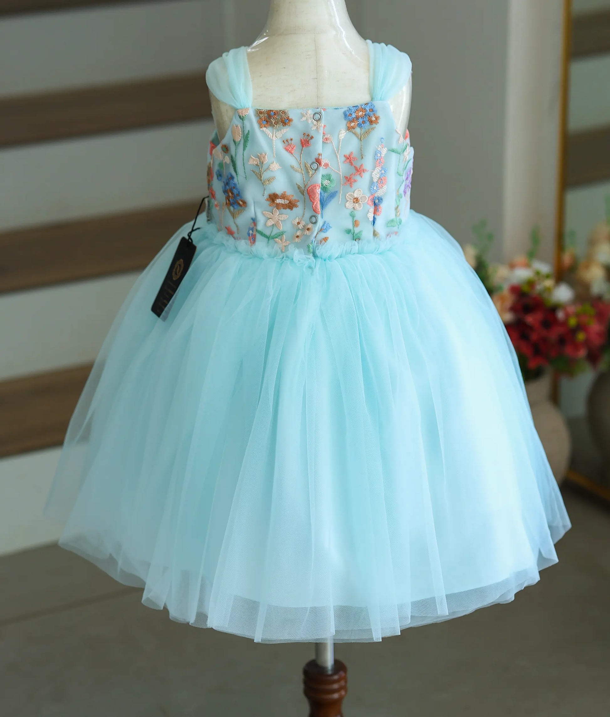 Back view of the sky blue frock showing the button closure.