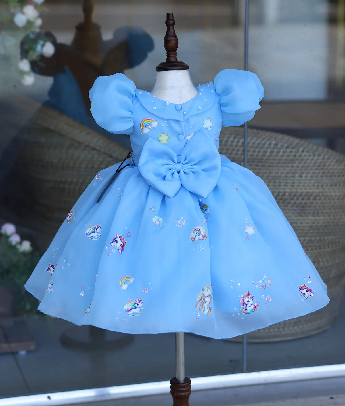 Sky blue organza unicorn frock for baby girl back view with puff sleeves and handworked bow