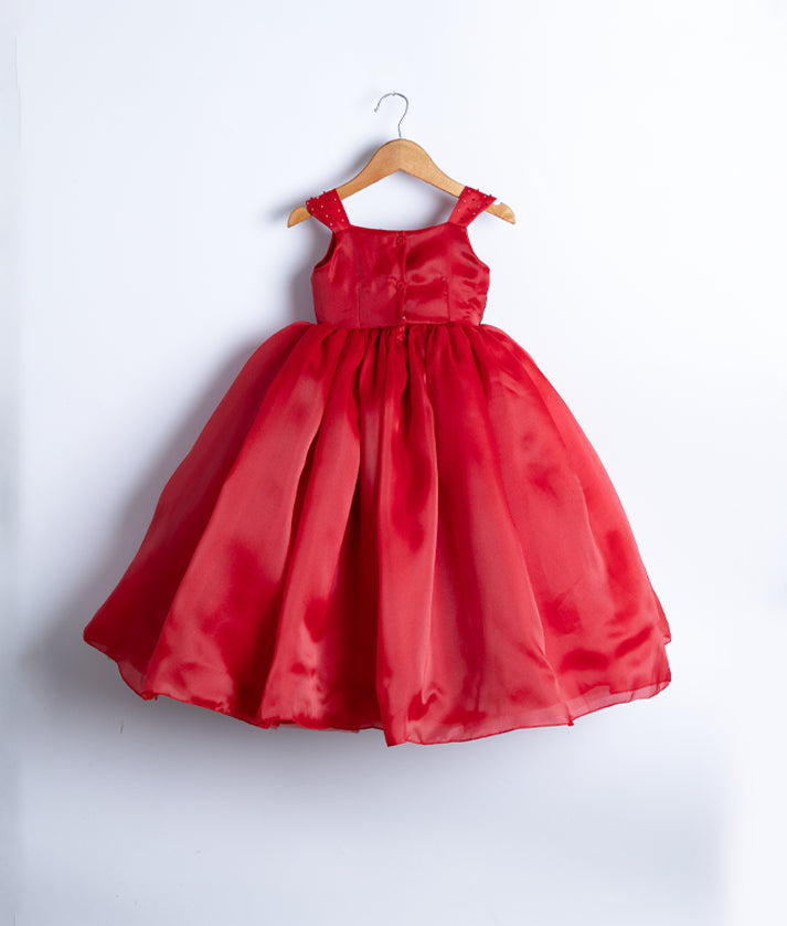 Back view of the red plain organza gown highlighting the square neckline and simple button closure