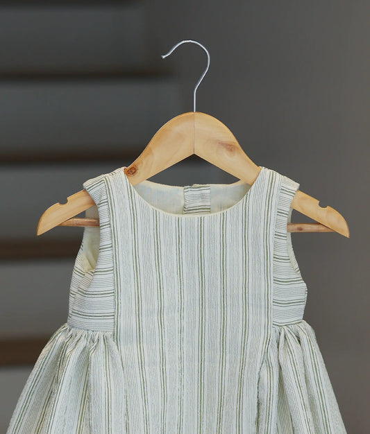 A close-up view of the bodice and round neckline of the green and white striped crush crape frock