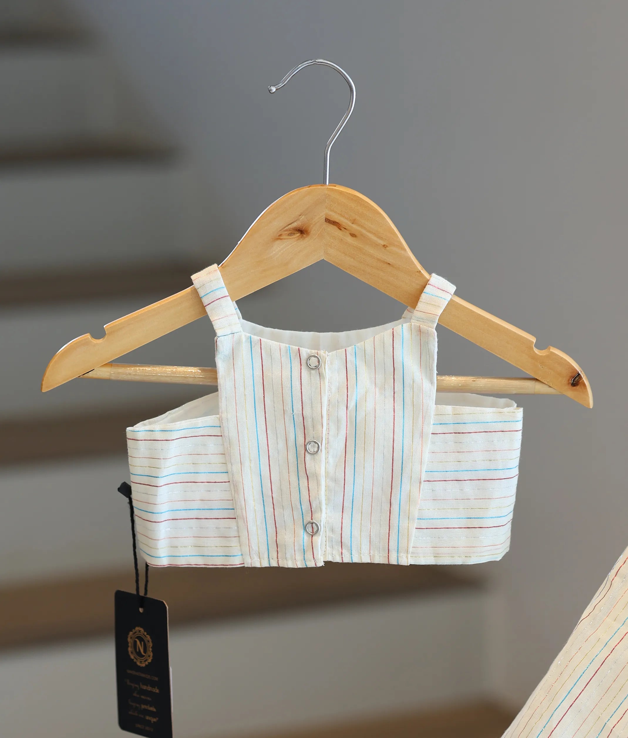 Back view of the striped top showing the neat button closures.