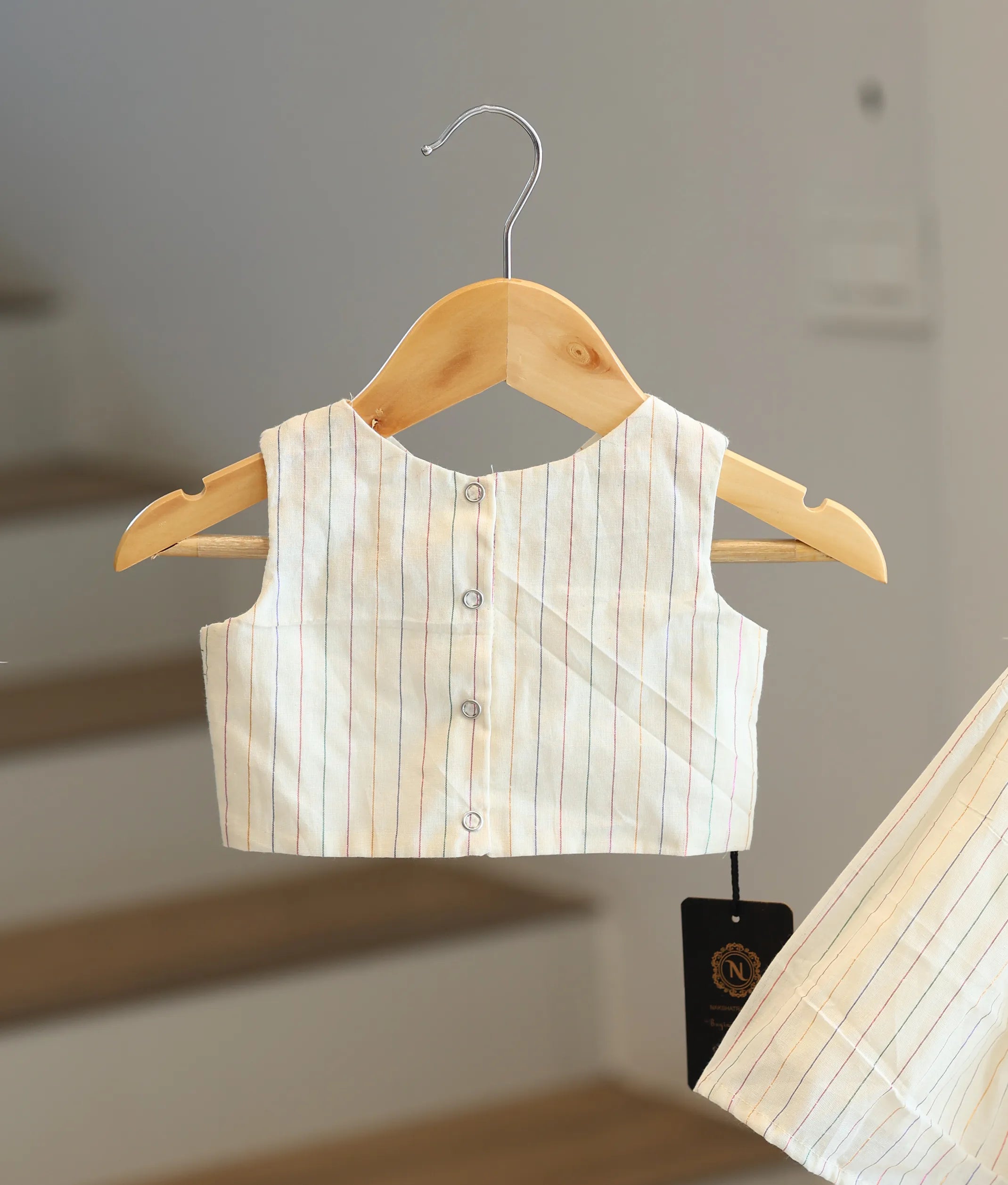 Back view of the striped top showing the neat button closures.