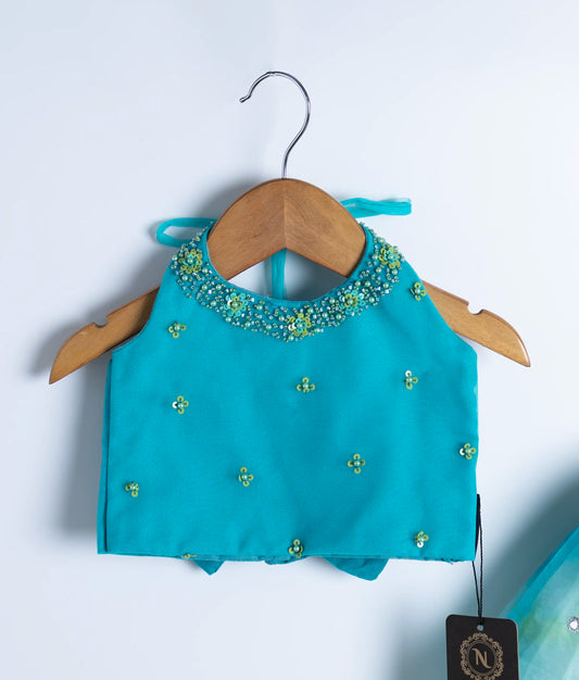 Close-up of teal swan theme dress showing detailed handmade applique work and embroidery on bodice