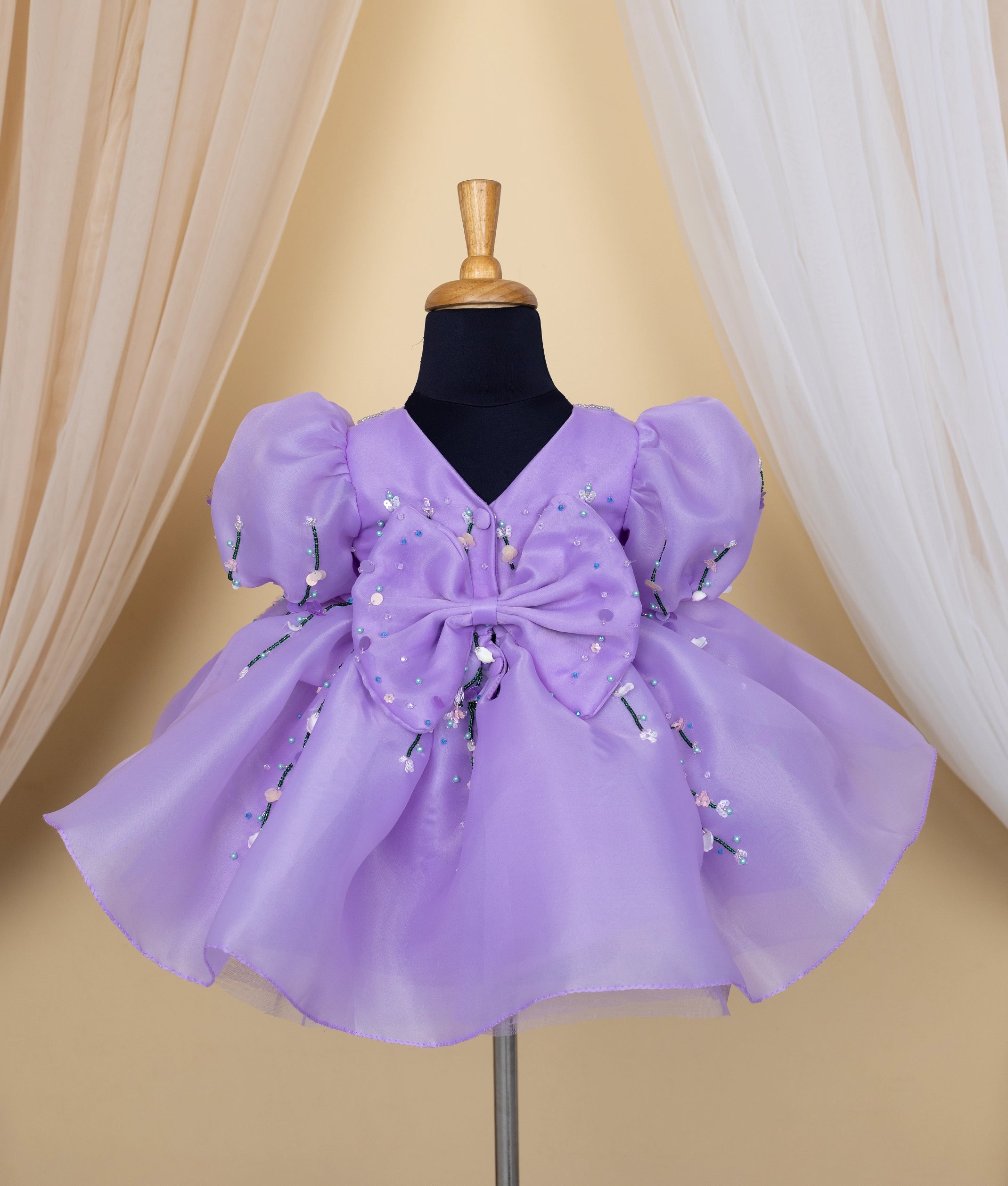 Side angle view of toddler purple frock showing layered tulle and floral embellishments