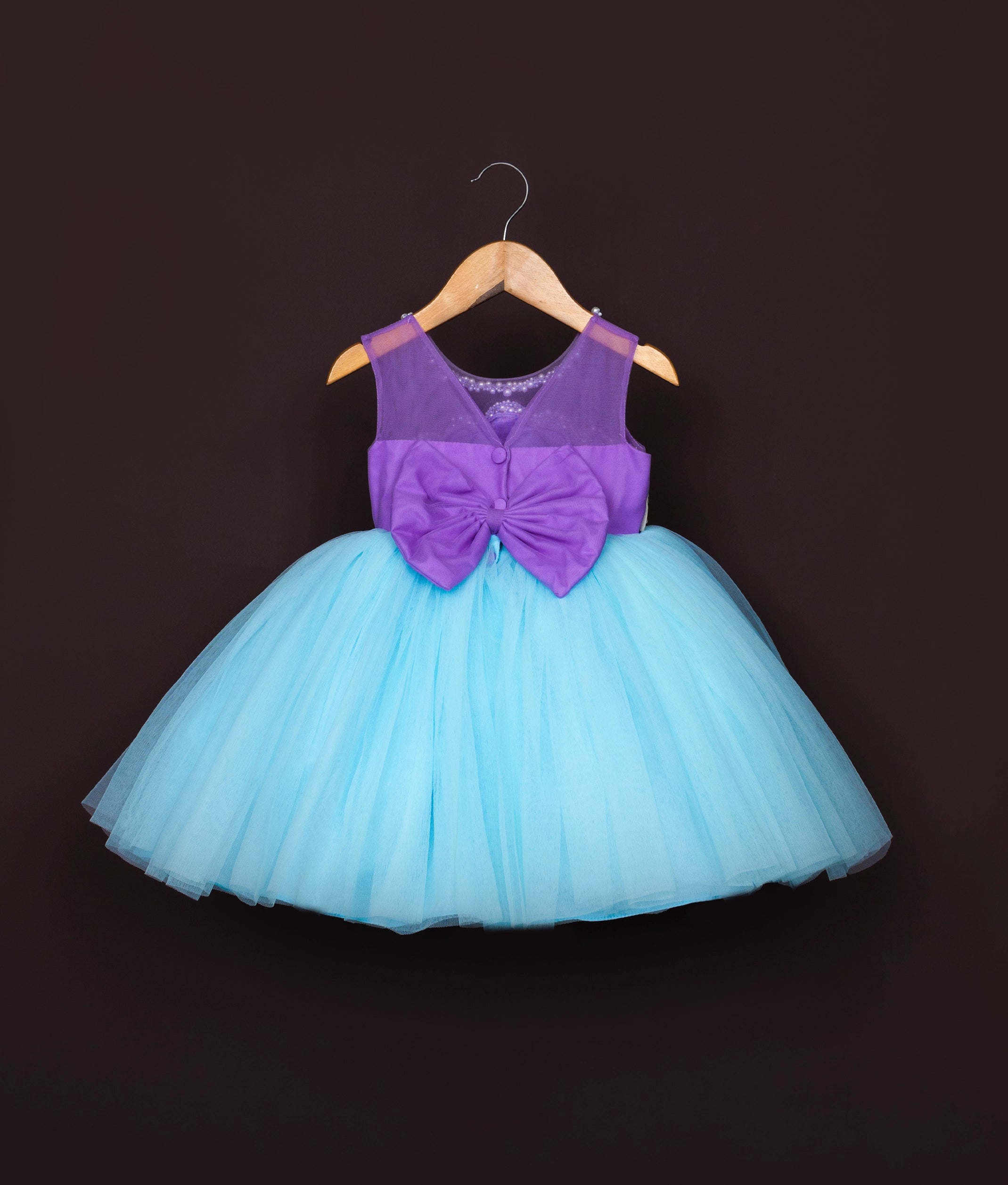Side view of turquoise and purple costume dress with mermaid-inspired color combination and full skirt