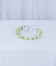 Delicate white and green floral baptism tiara for baby girls, handcrafted for a soft and elegant ceremony look.