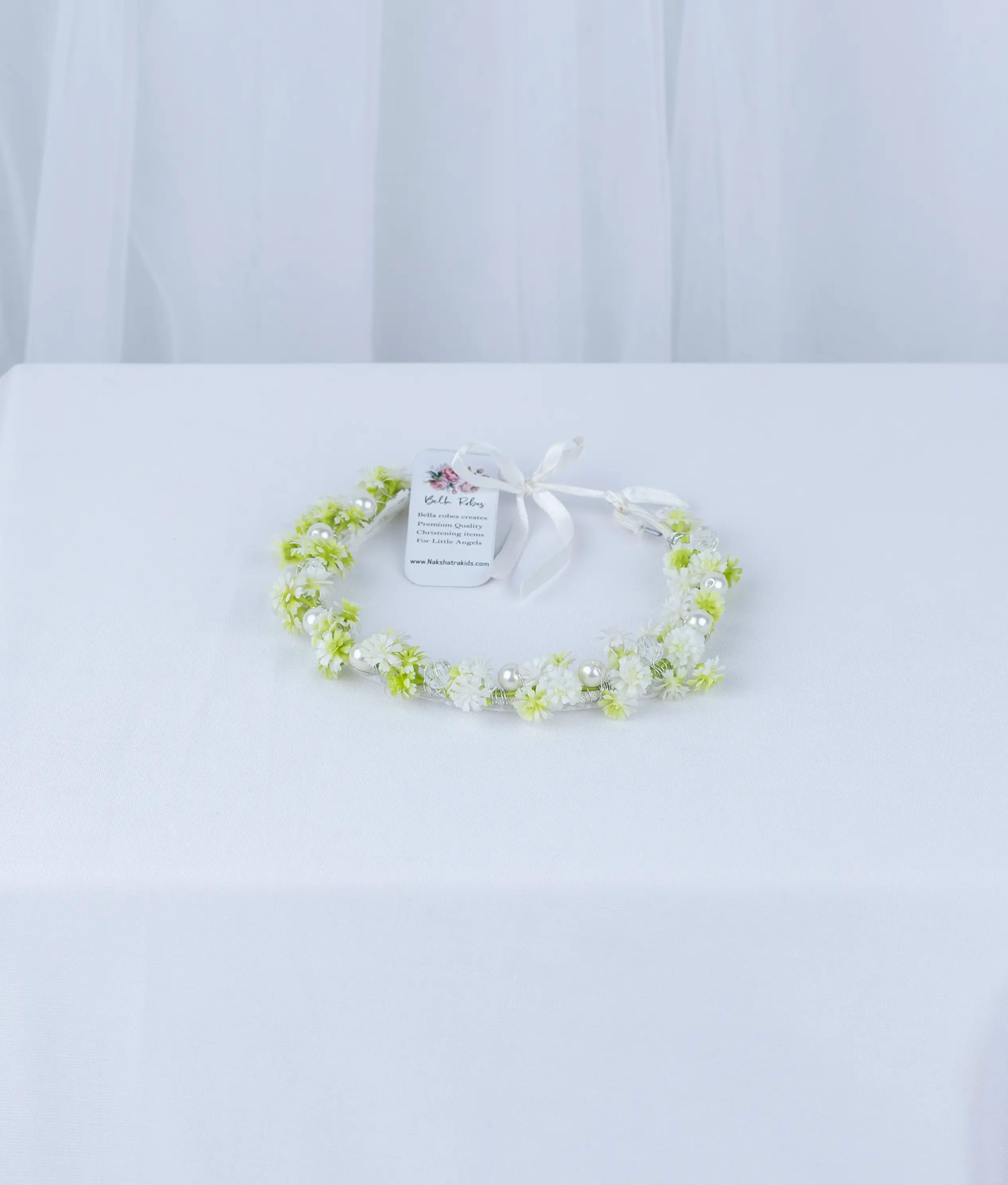 Delicate white and green floral baptism tiara for baby girls, handcrafted for a soft and elegant ceremony look.