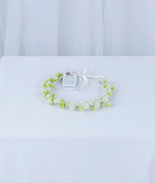 Delicate white and green floral baptism tiara for baby girls, handcrafted for a soft and elegant ceremony look.