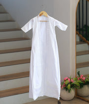 Full front view off white cotton baby baptism gown with an open-front floral lace overlayer hanging on hanger