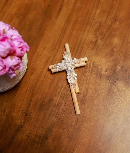 Front view of a handcrafted pure white floral baptism cross decorated with white flowers and pearls