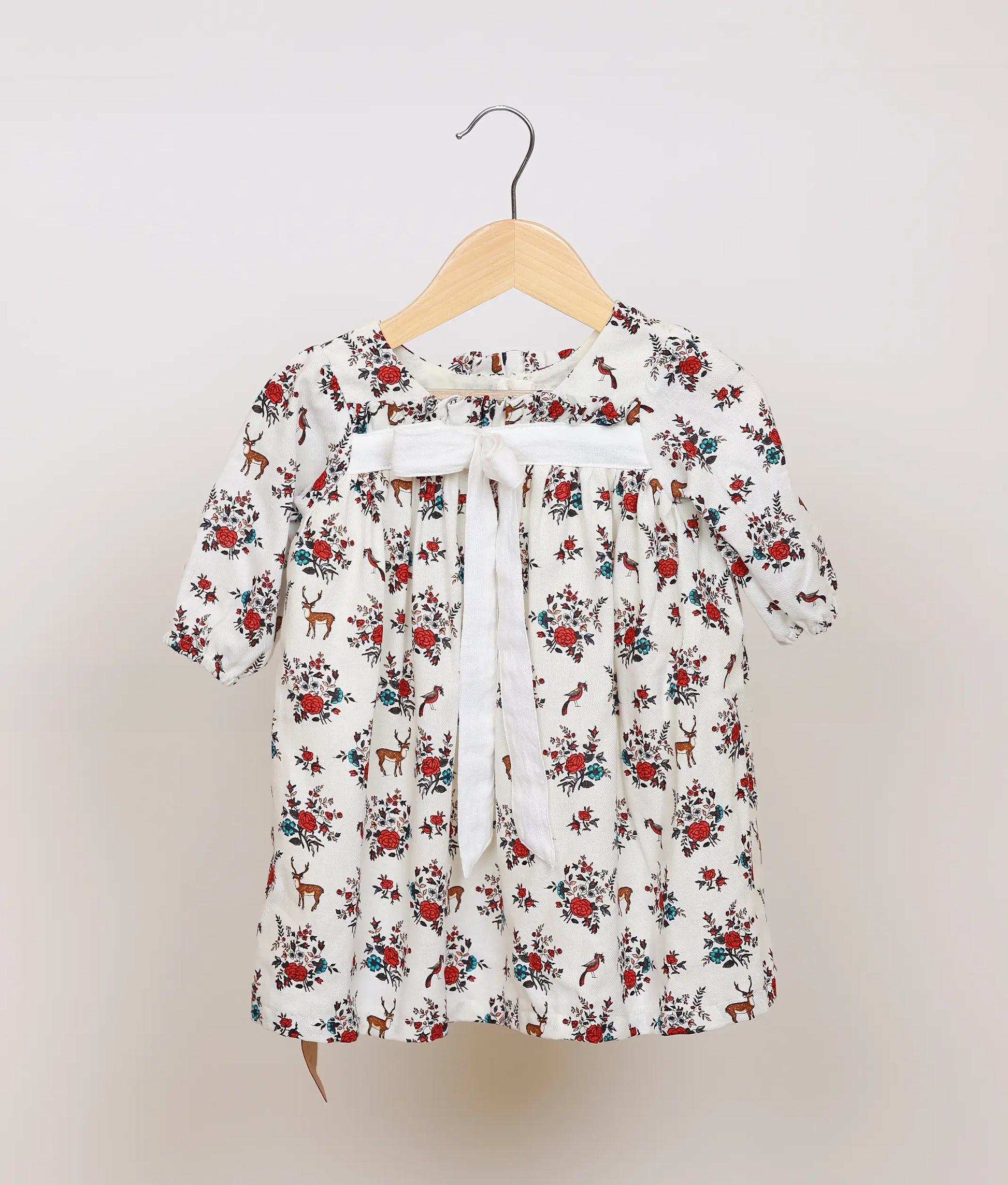 White floral printed cotton frock for baby girl, full front view showing flared skirt and puff sleeves.